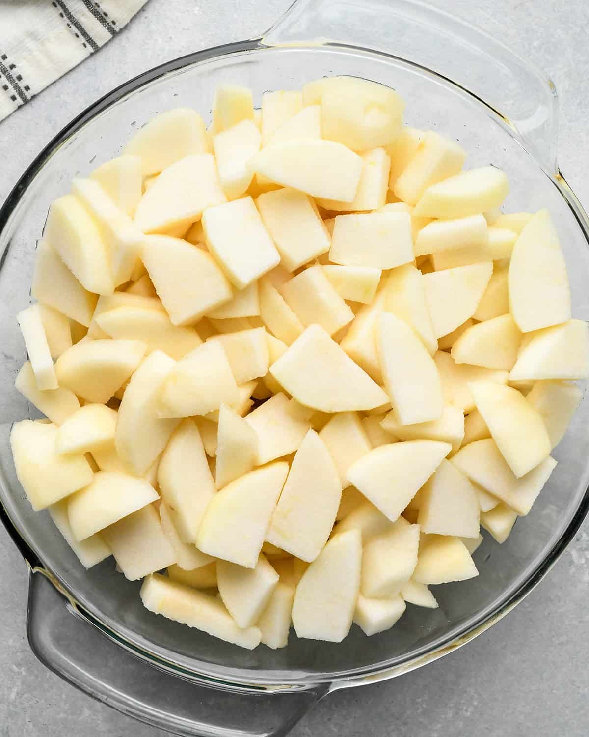 How to Make Pear Pie - sliced pears in a glass bowl before cooking