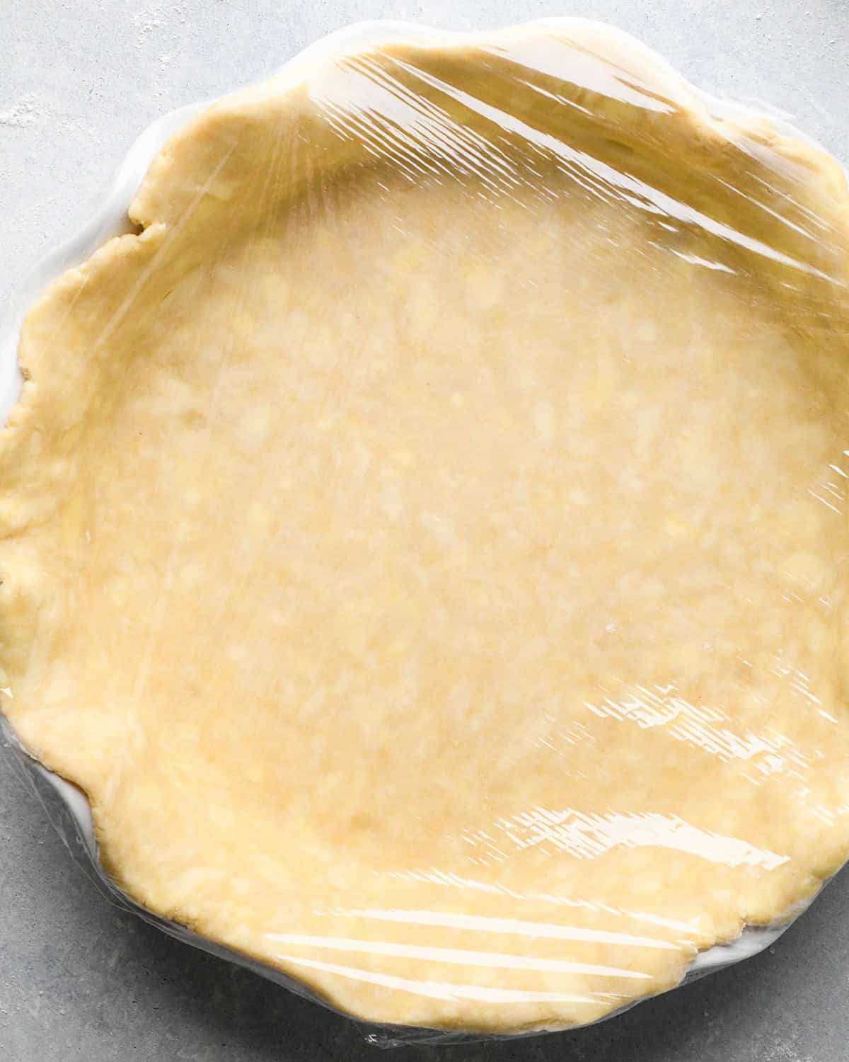 How to Make Pear Pie - the bottom crust with plastic wrap on top
