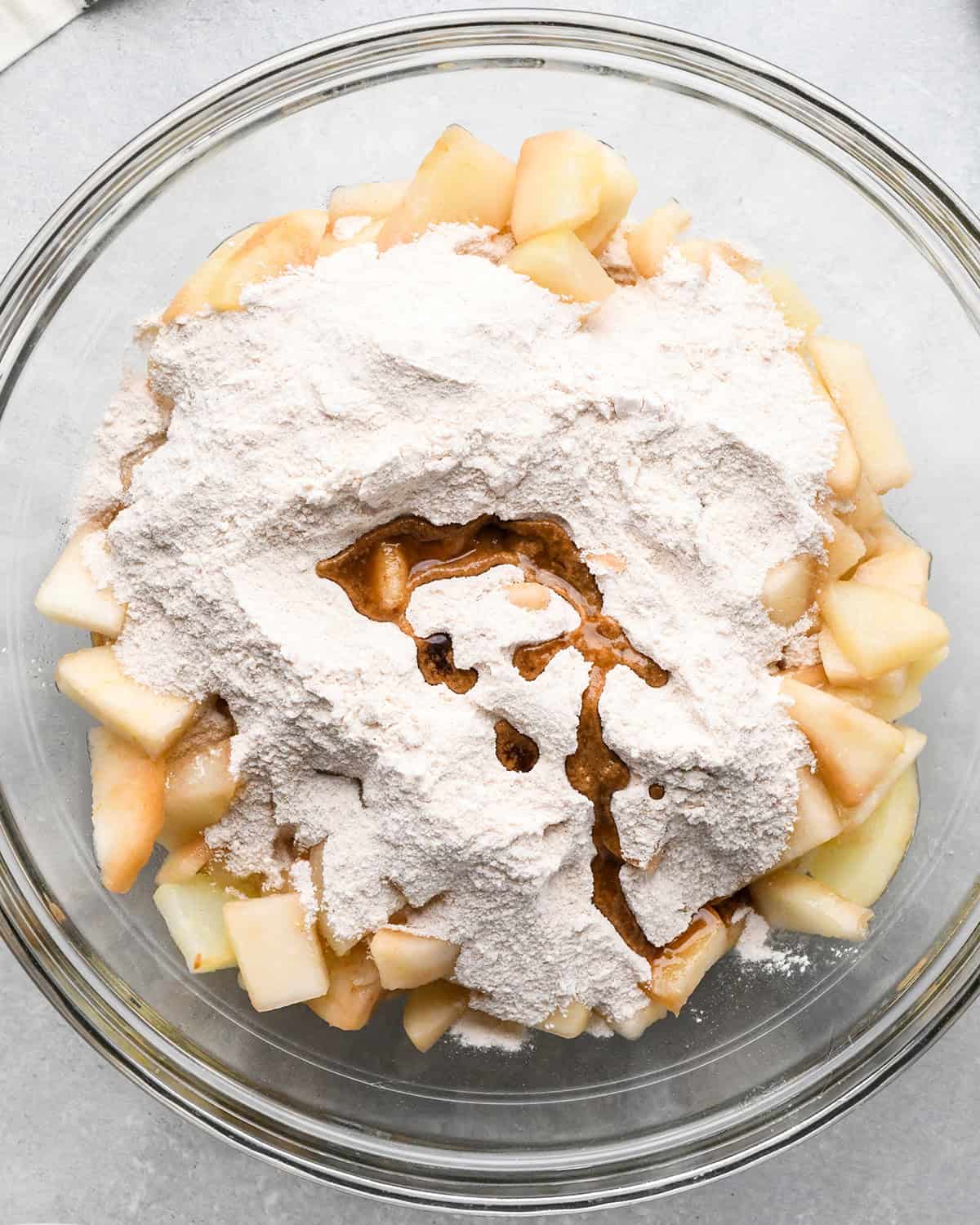 How to Make Pear Pie - dry ingredients and vanilla added to pears in a bowl