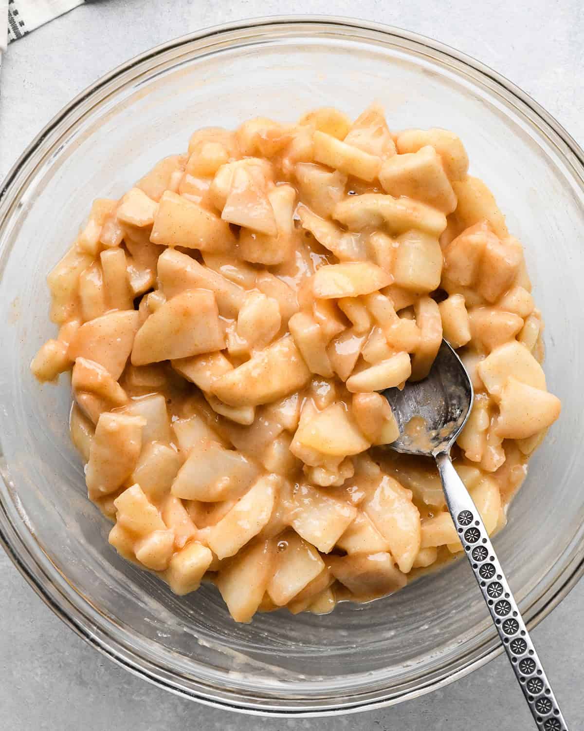 pear pie filling in a bowl with a spoon