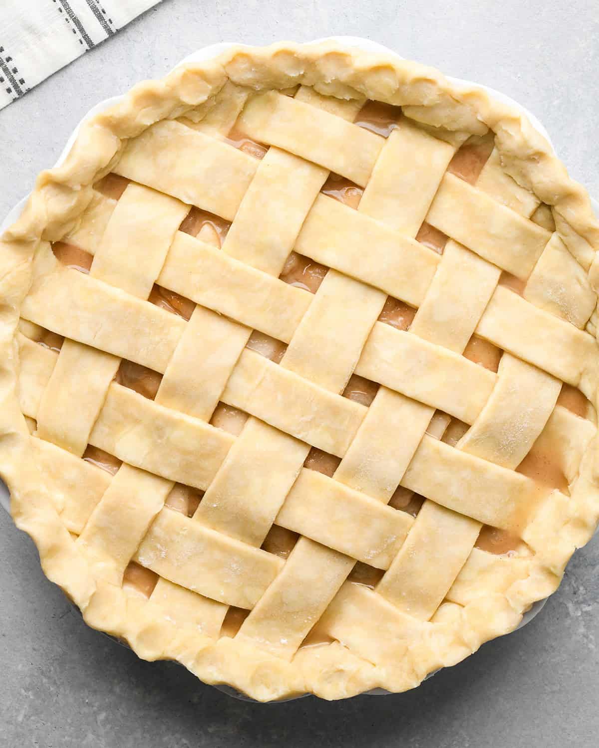 pear pie with lattice crust before baking