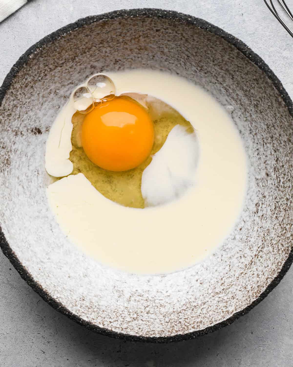 how to make pear pie - egg wash ingredients in a bowl before whisking