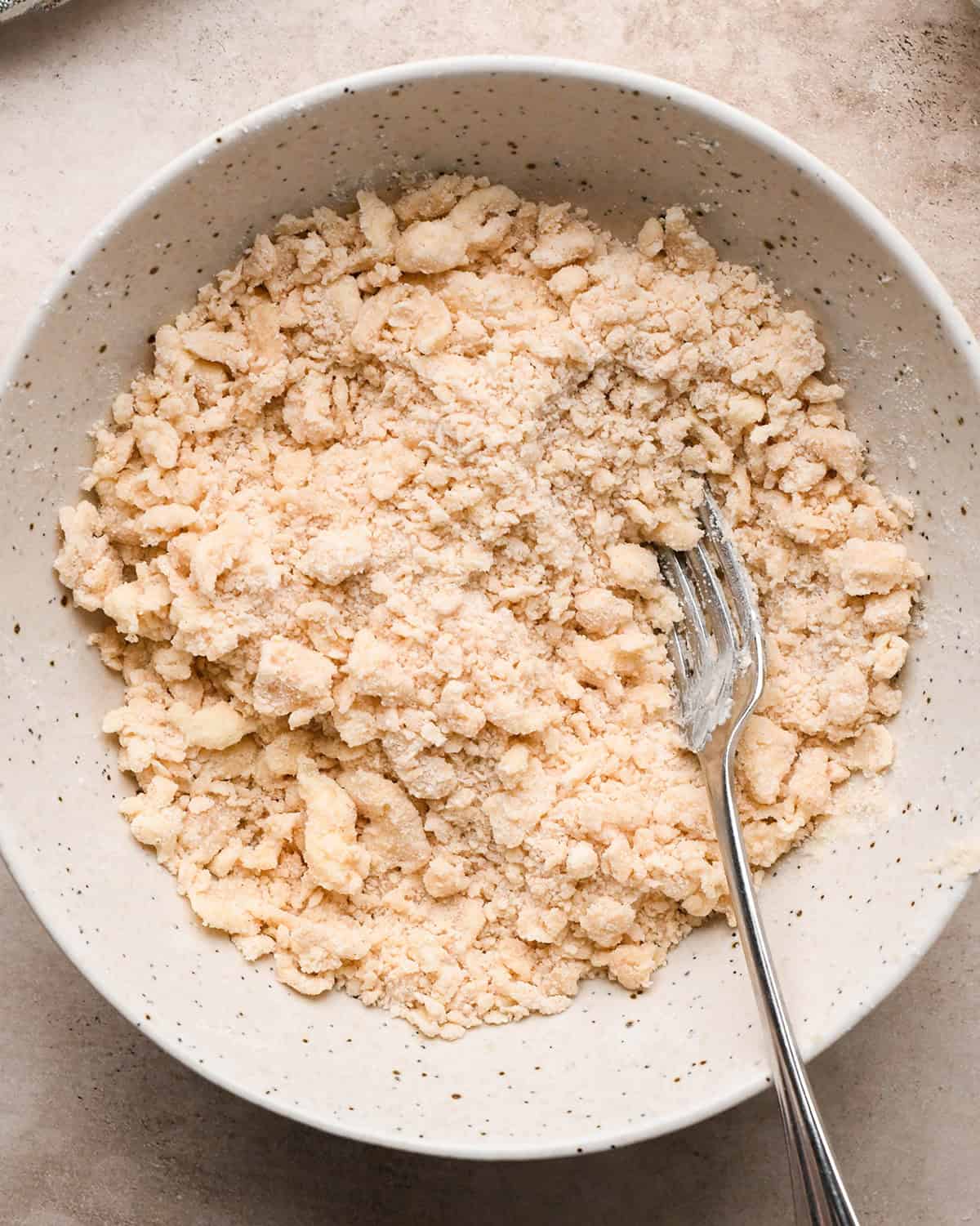 finished pear crumble topping in a bowl with a fork