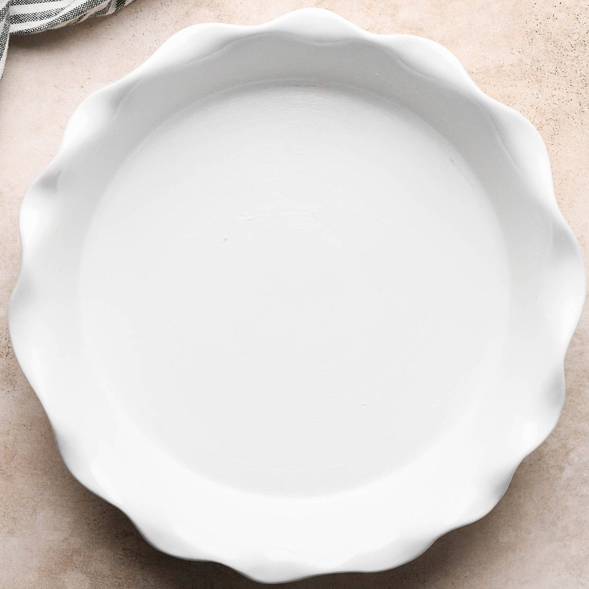 a round white greased pie plate