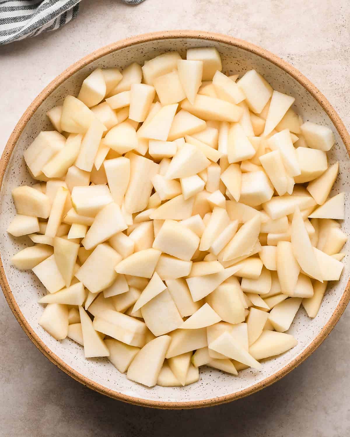 a bowl of peeled and cut pears 