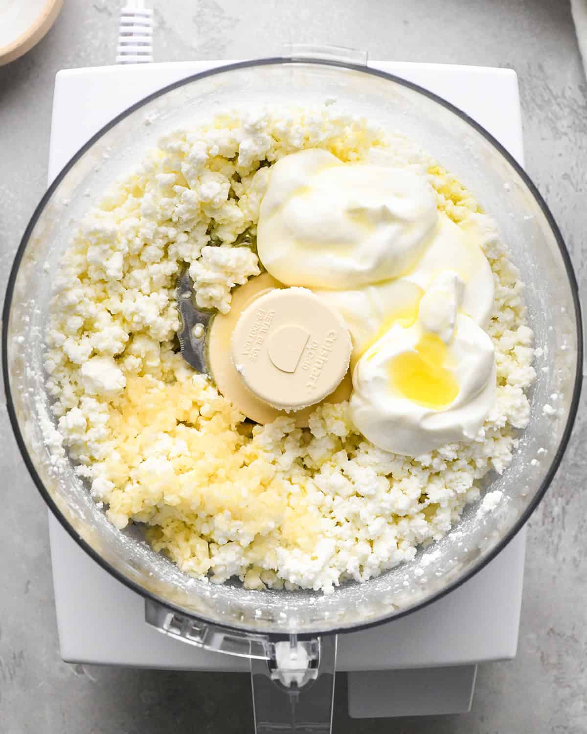 How to Make Whipped Goat Cheese - adding ingredients to goat cheese in food processor