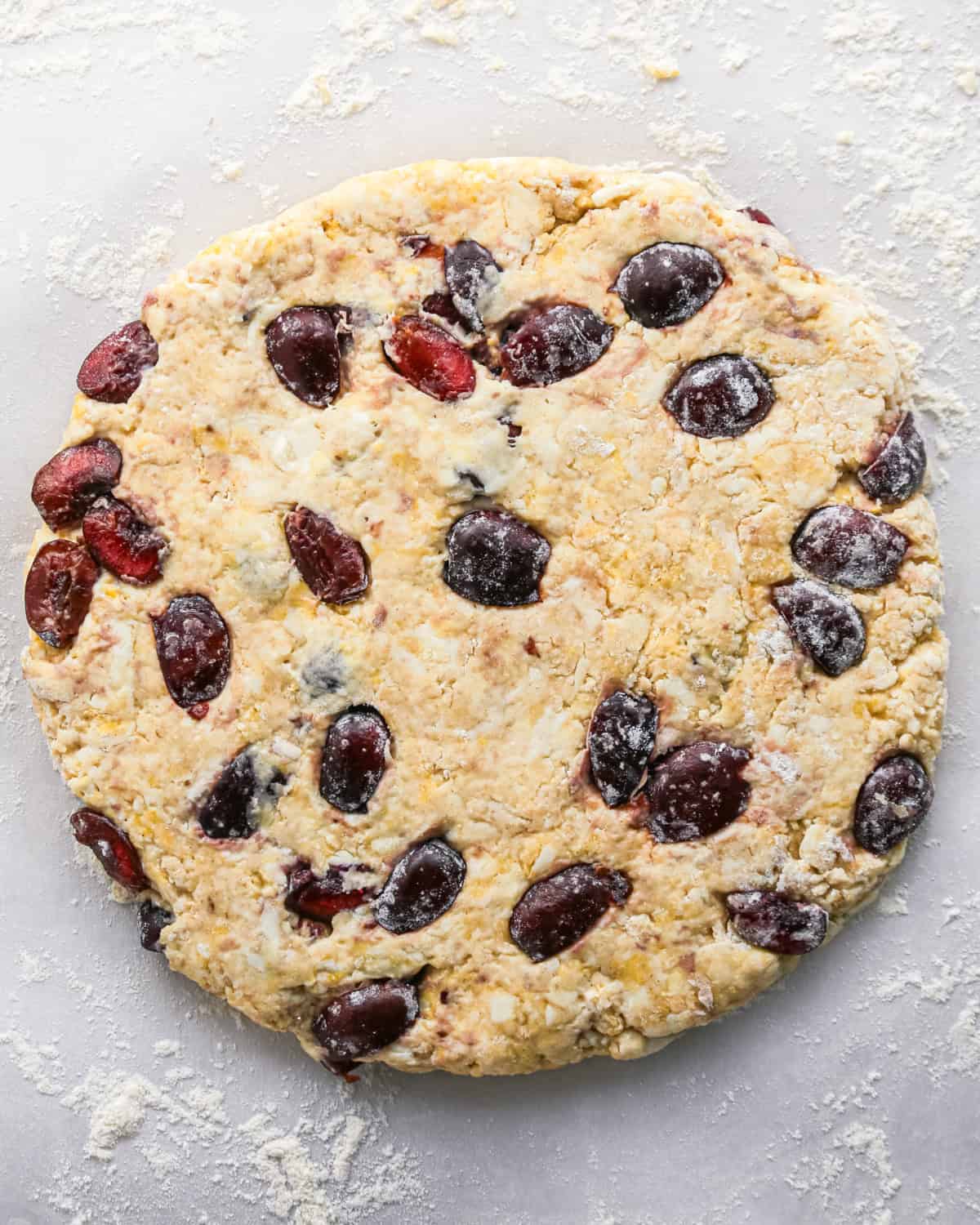 how to make cherry scones - scone dough with cherries formed into a round disc