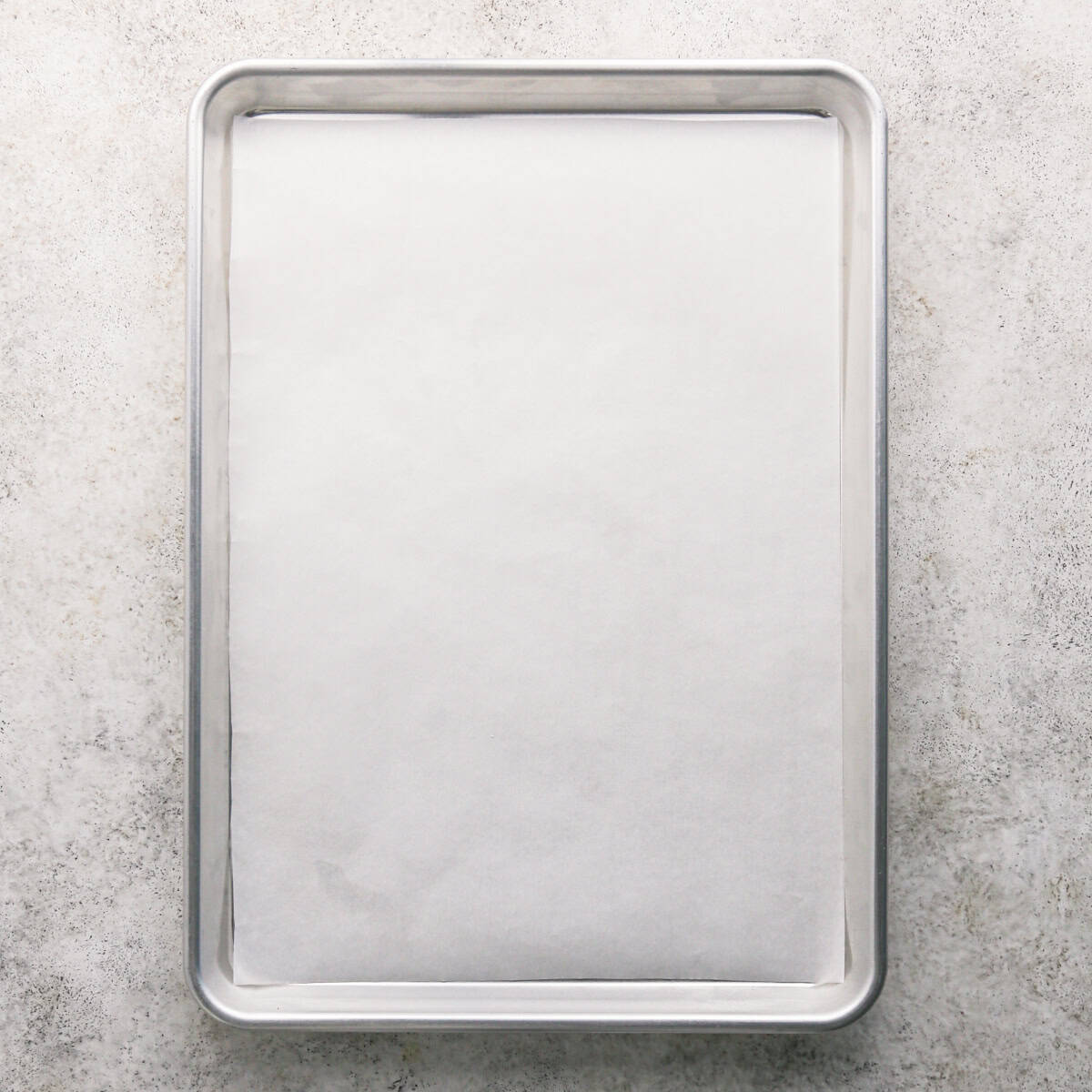 a silver baking sheet lined with white parchment paper