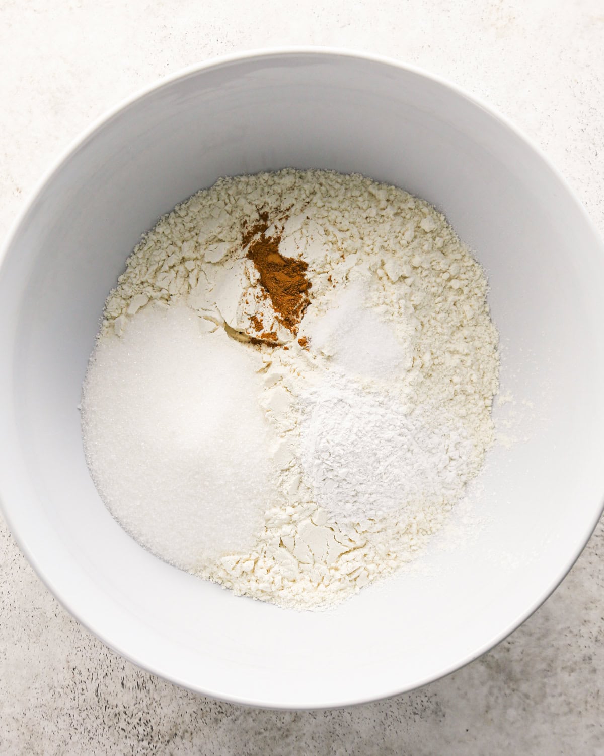 how to make cherry scones - dry ingredients in a white bowl before mixing
