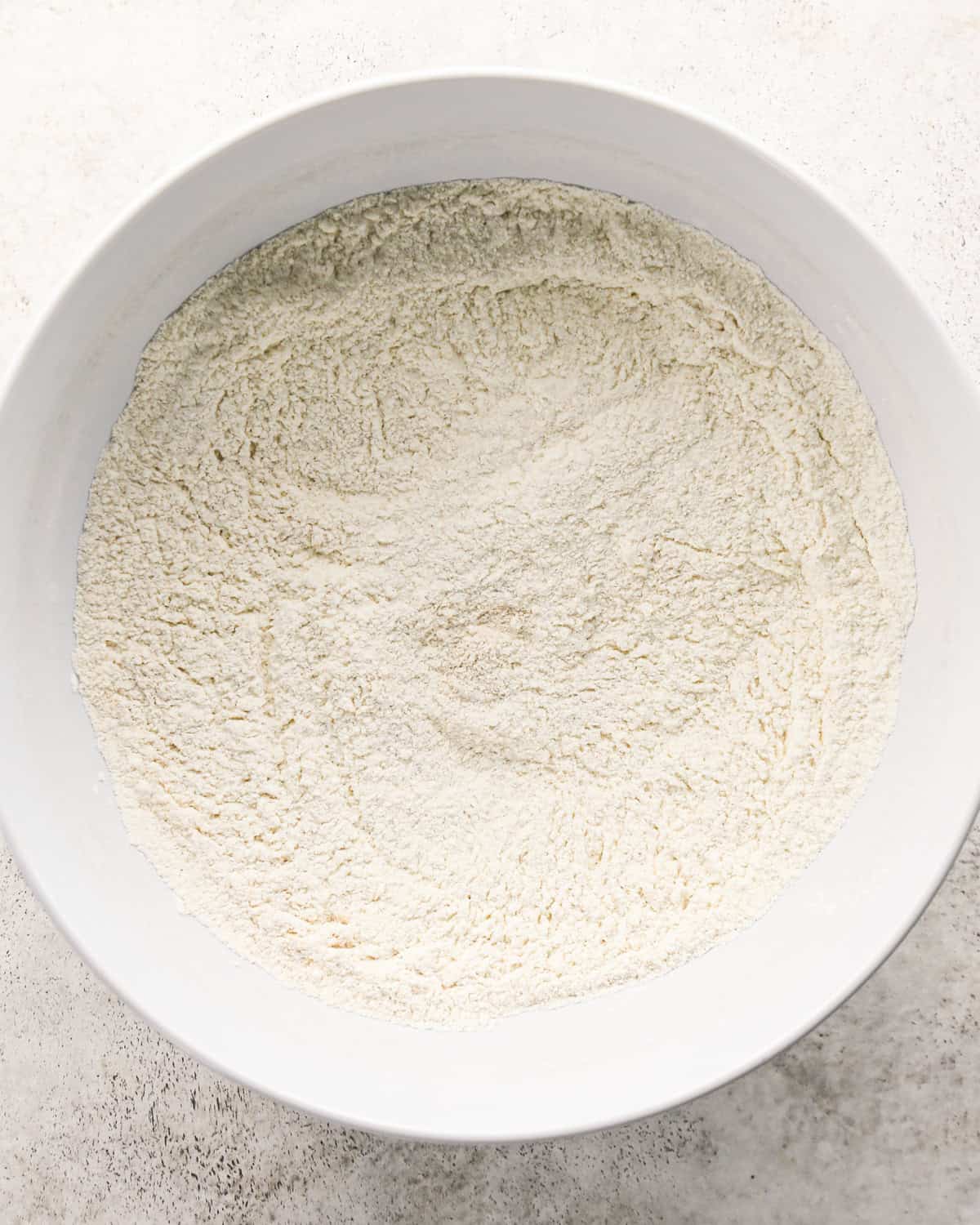 how to make cherry scones - dry ingredients in a white bowl after mixing