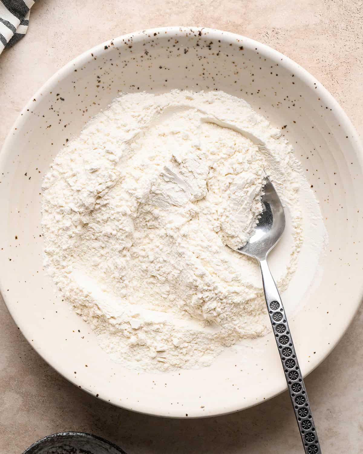 making pretzel cookies - dry ingredients mixed in a bowl with a spoon