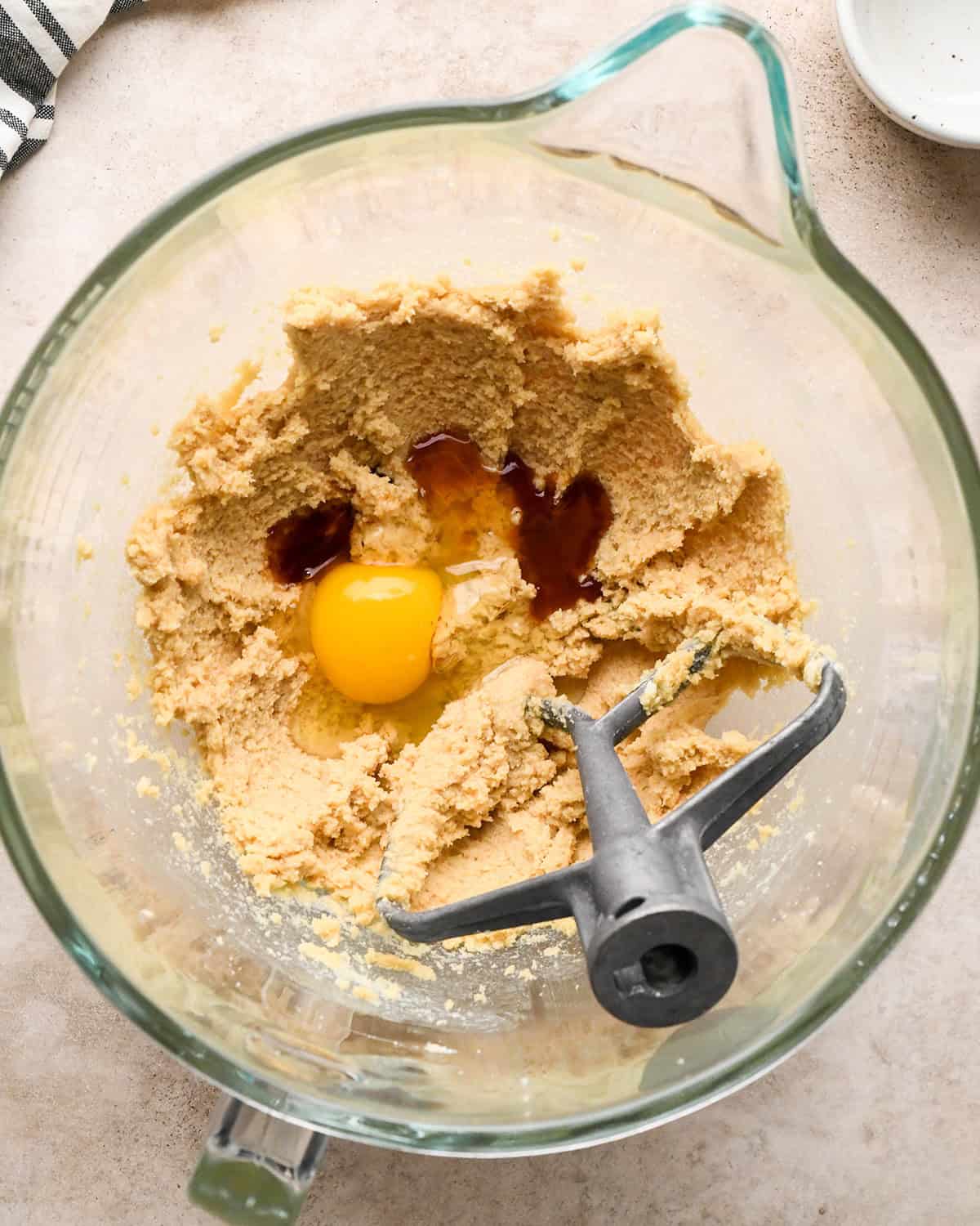 making pretzel cookies - egg and vanilla added to beaten butter sugar mixture before mixing