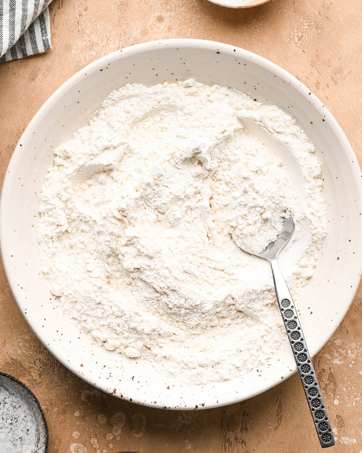 making chocolate chip waffles - dry ingredients mixed in a bowl with a spoon