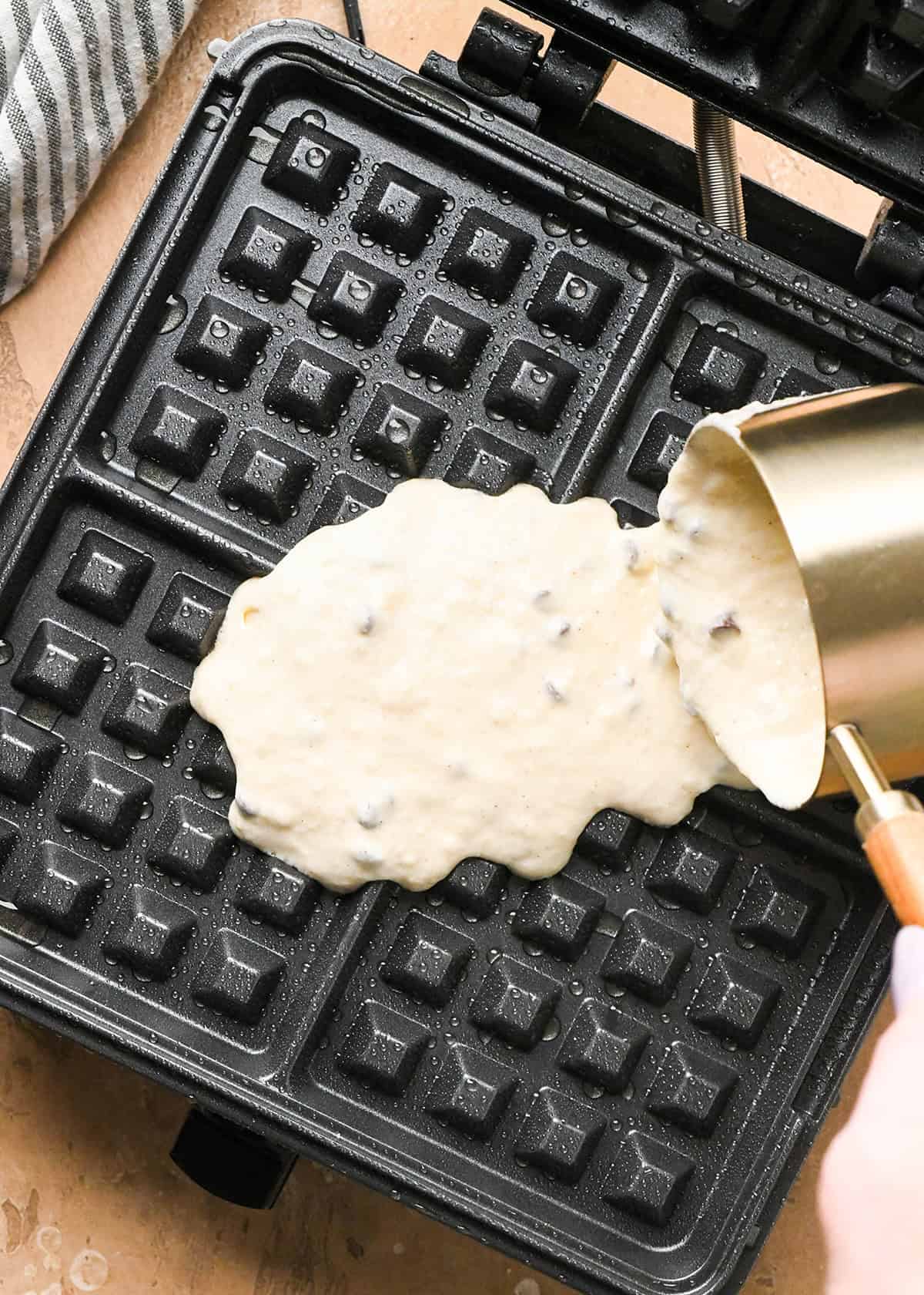 Chocolate Chip Waffles batter being poured onto a waffle maker