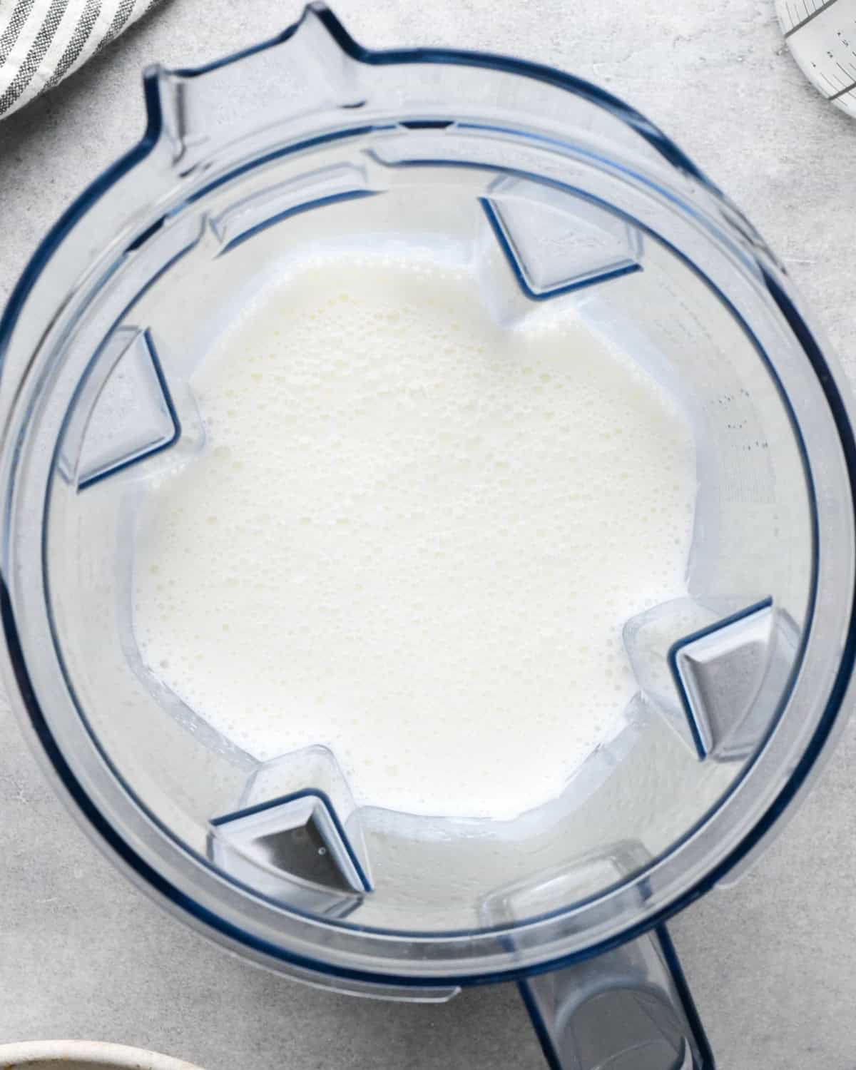 milk and cottage cheese in a blending container after blending making macaroni and cottage cheese