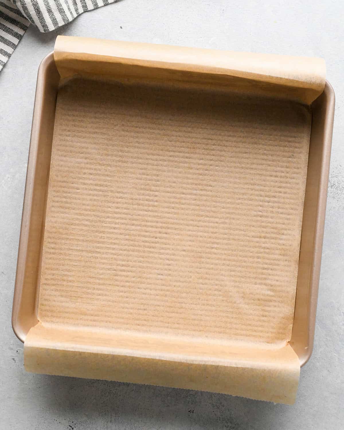 an 8 inch square pan lined with parchment paper