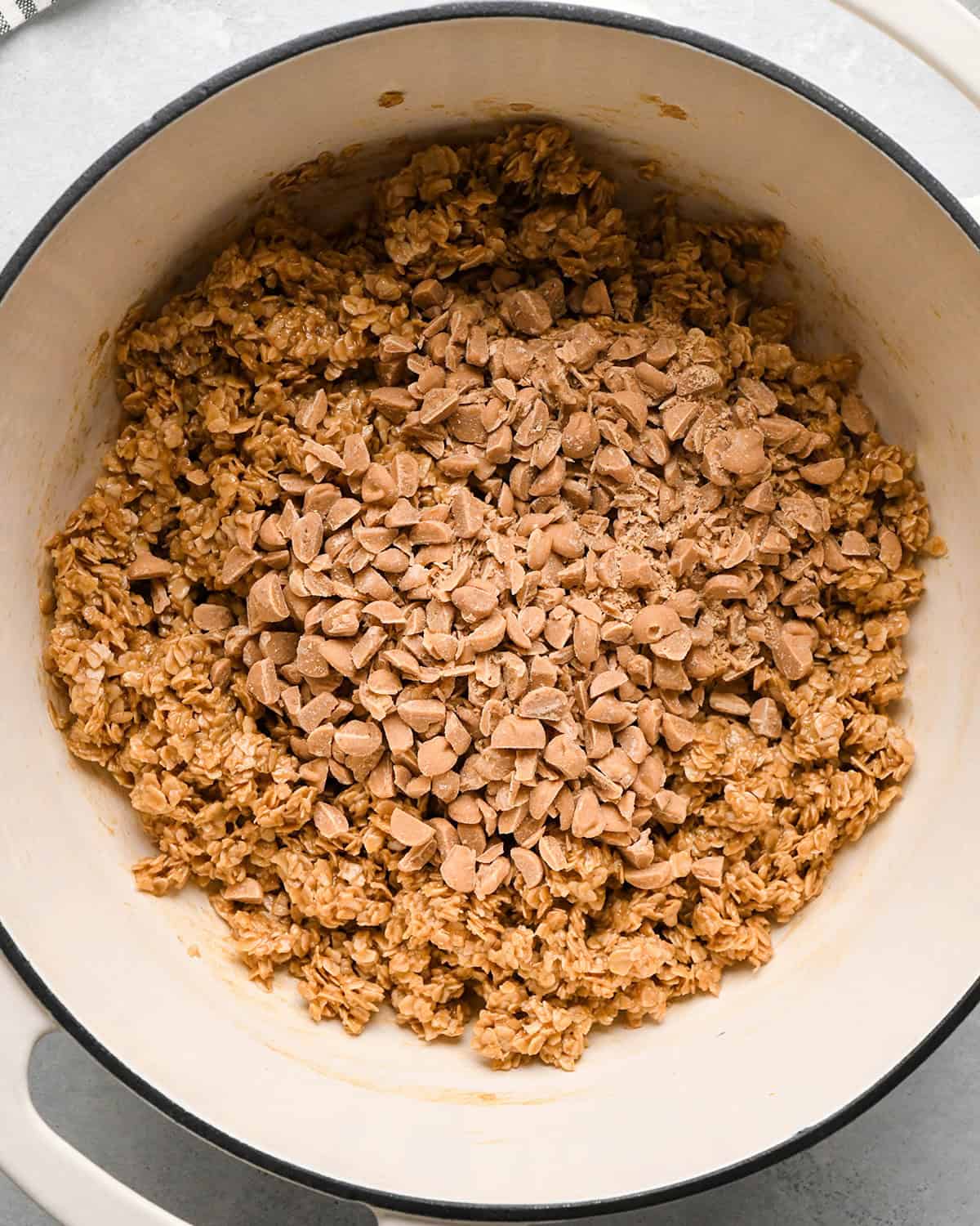 making Peanut Butter Granola Bars - chopped peanut butter chips added before stirring