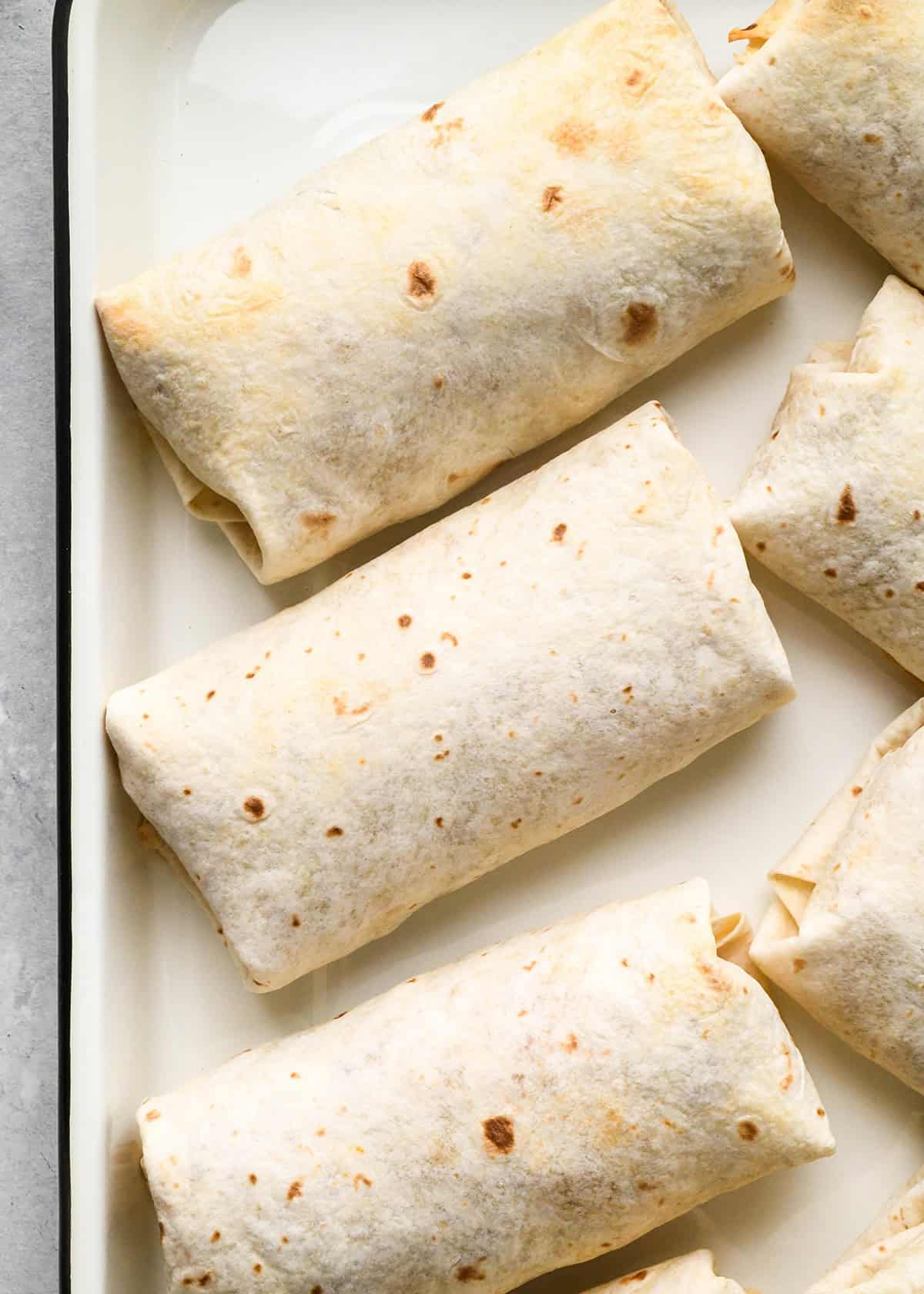 breakfast burritos on a baking sheet after baking