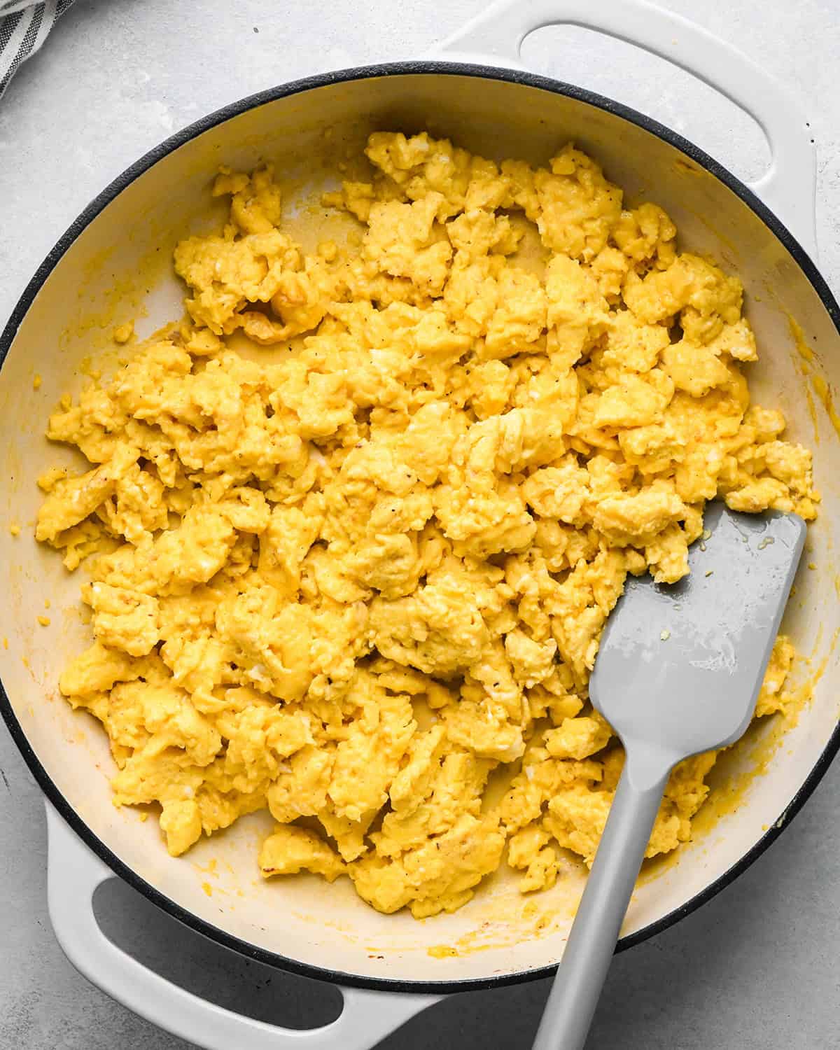 How to Make Breakfast Burritos - scrambled eggs in a skillet with a spatula