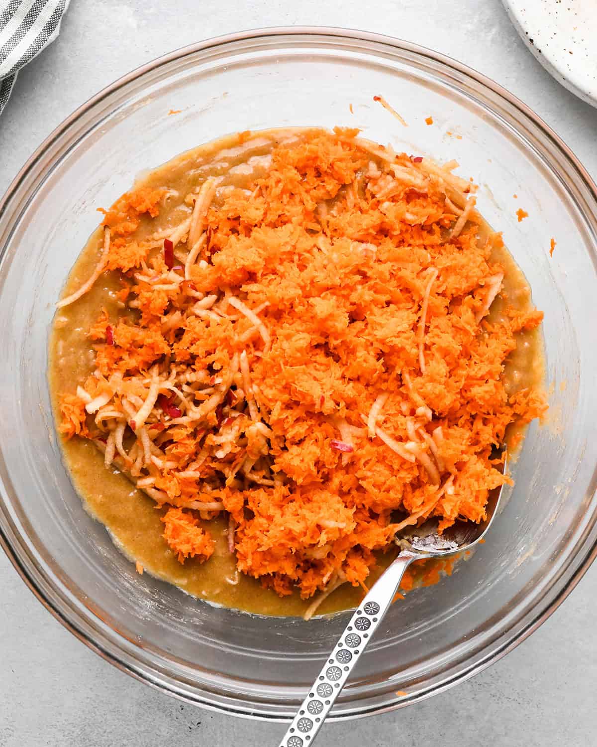 how to make Morning Glory Muffins - shredded carrots and apples added before mixing