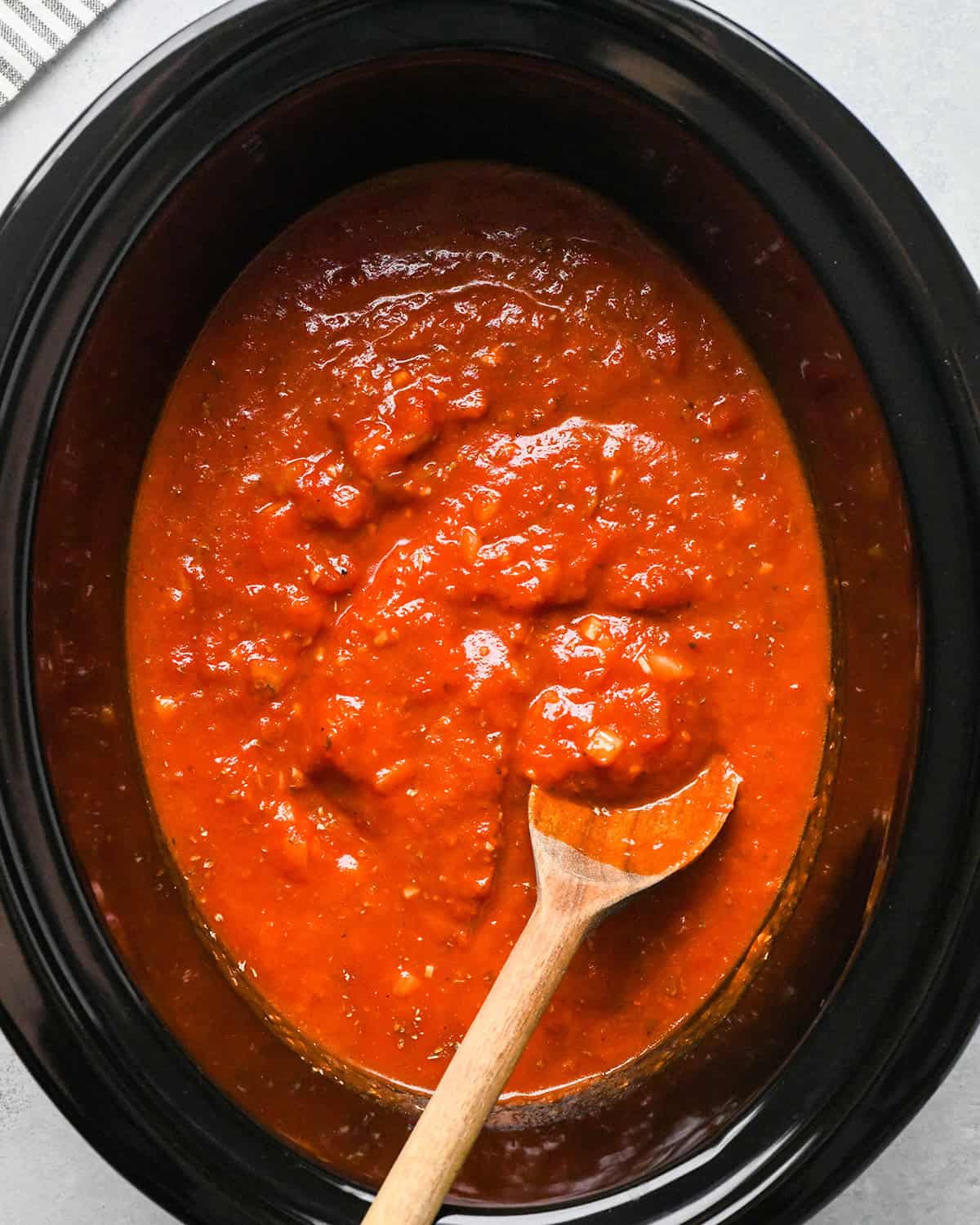 making slow cooker meatballs - sauce ingredients in a crock pot after mixing