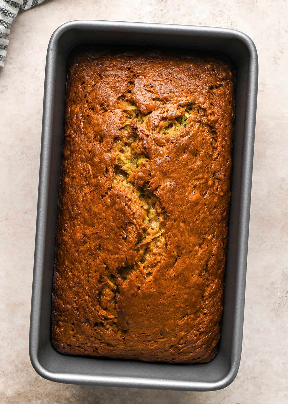 zucchini banana bread in a loaf pan after baking