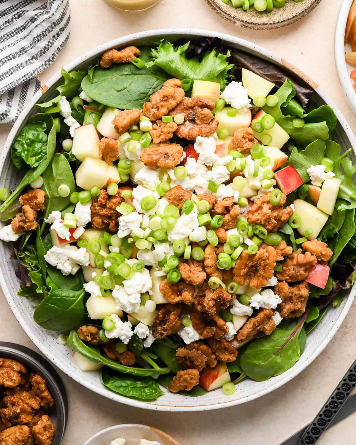 assembling apple salad - green onion and candied walnuts added 
