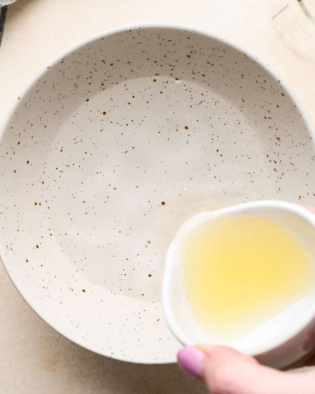 making Apple Salad - lemon juice being poured into a bowl