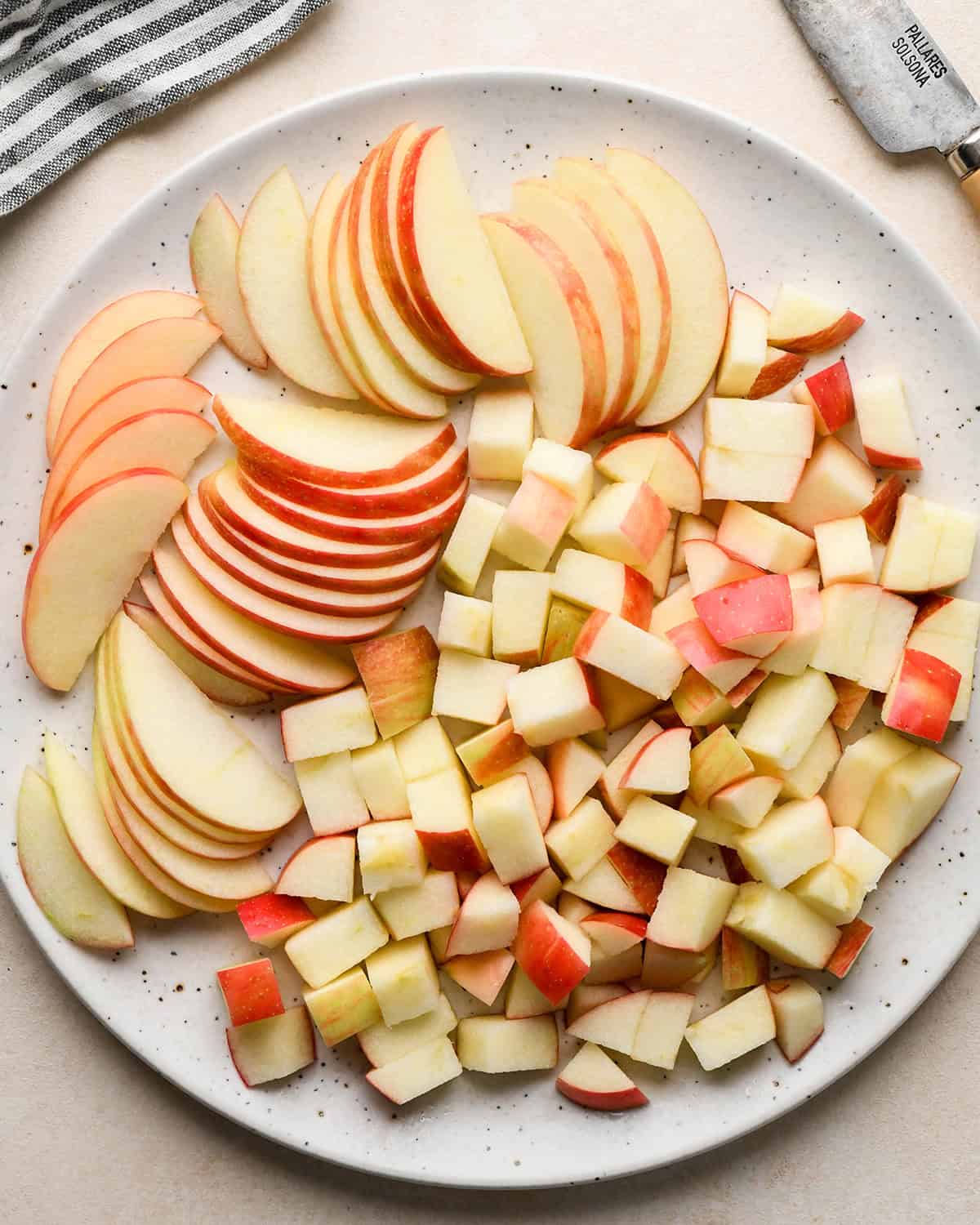 making Apple Salad - diced and sliced apples on a plate