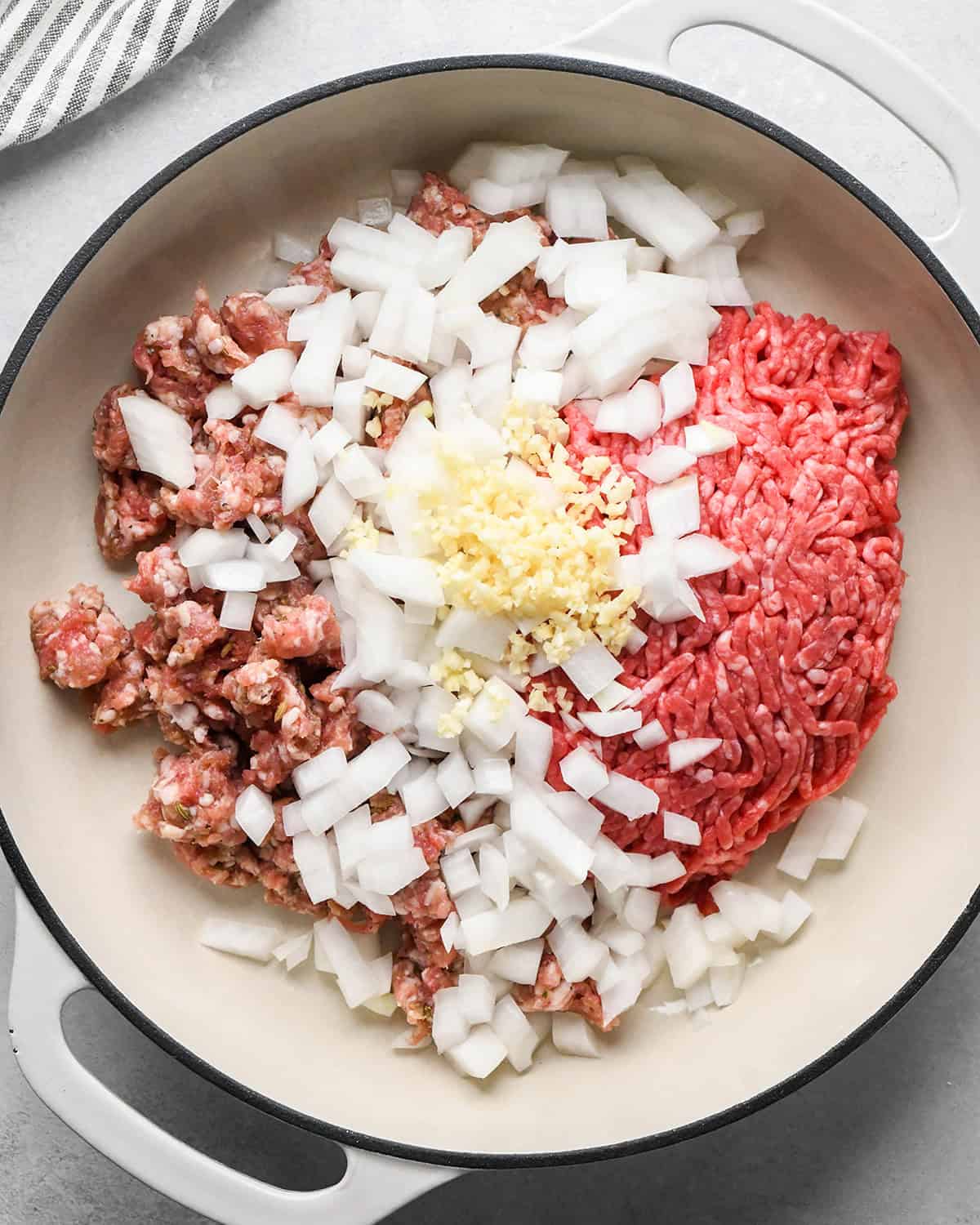 making Baked Mostaccioli - sausage, ground beef onion and garlic in a skillet before cooking