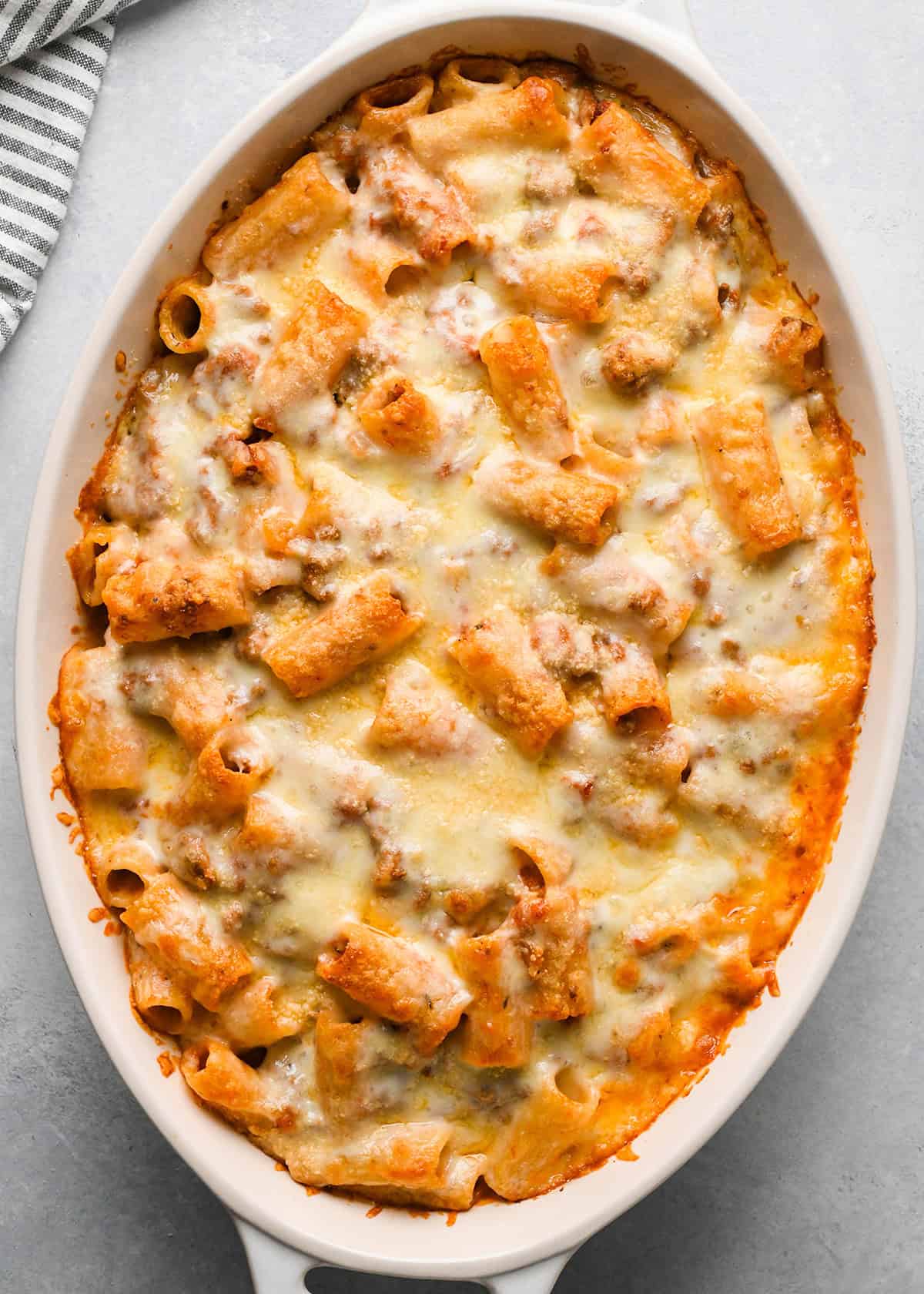 Baked Mostaccioli in a white baking dish after baking