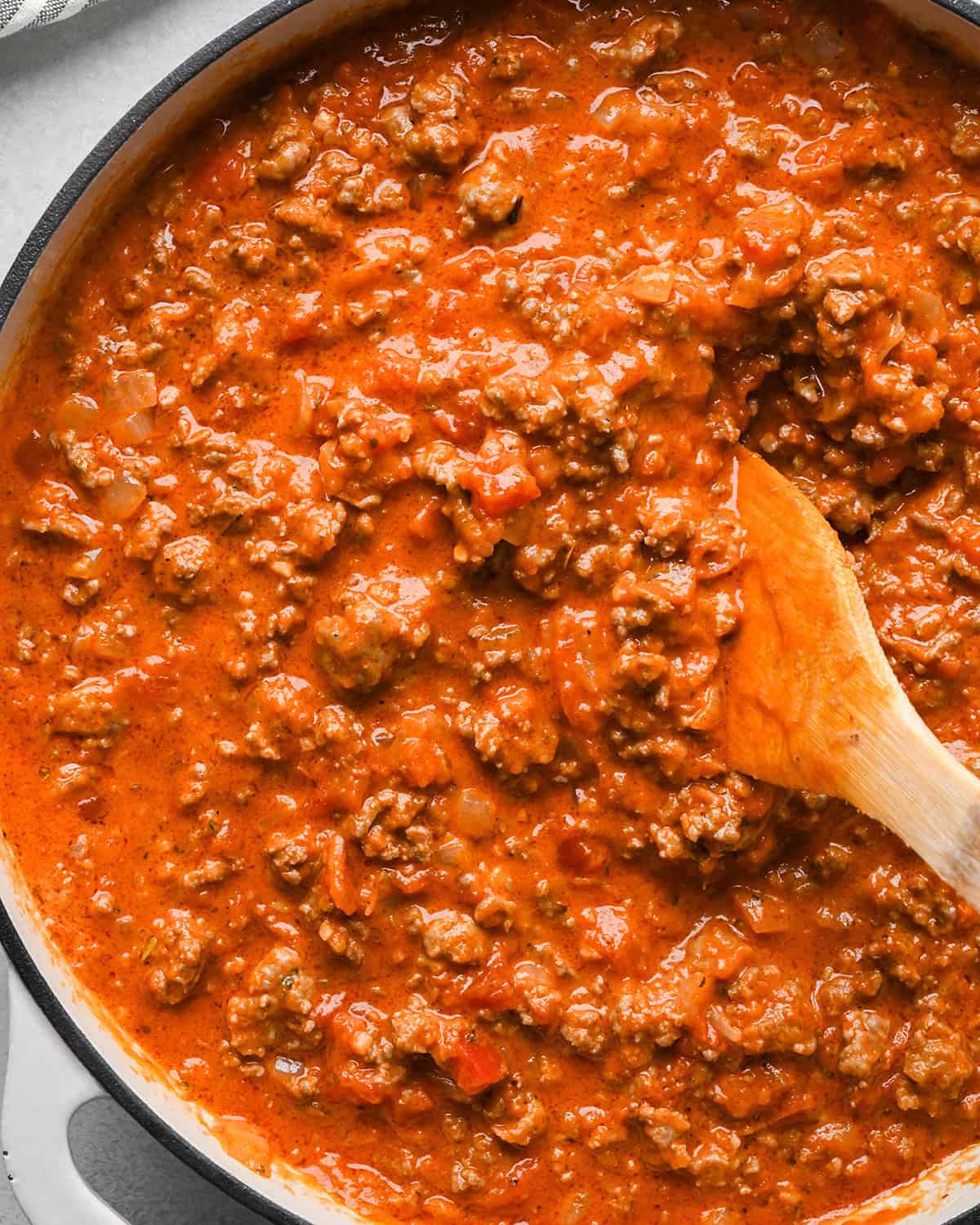 Baked Mostaccioli sauce in a saucepan with a wooden spatula