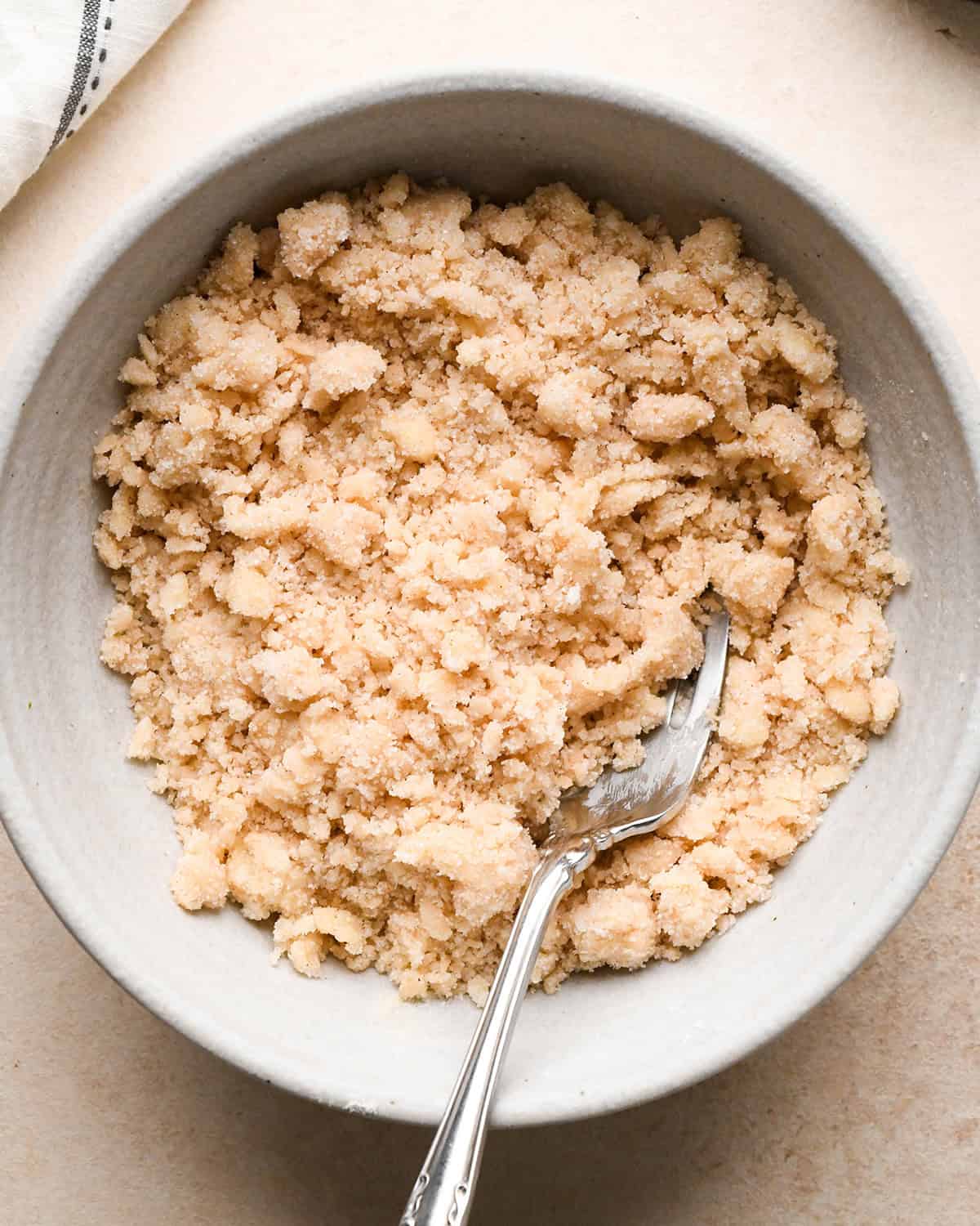 making Banana Crumb Muffins - crumb topping in a bowl with a fork