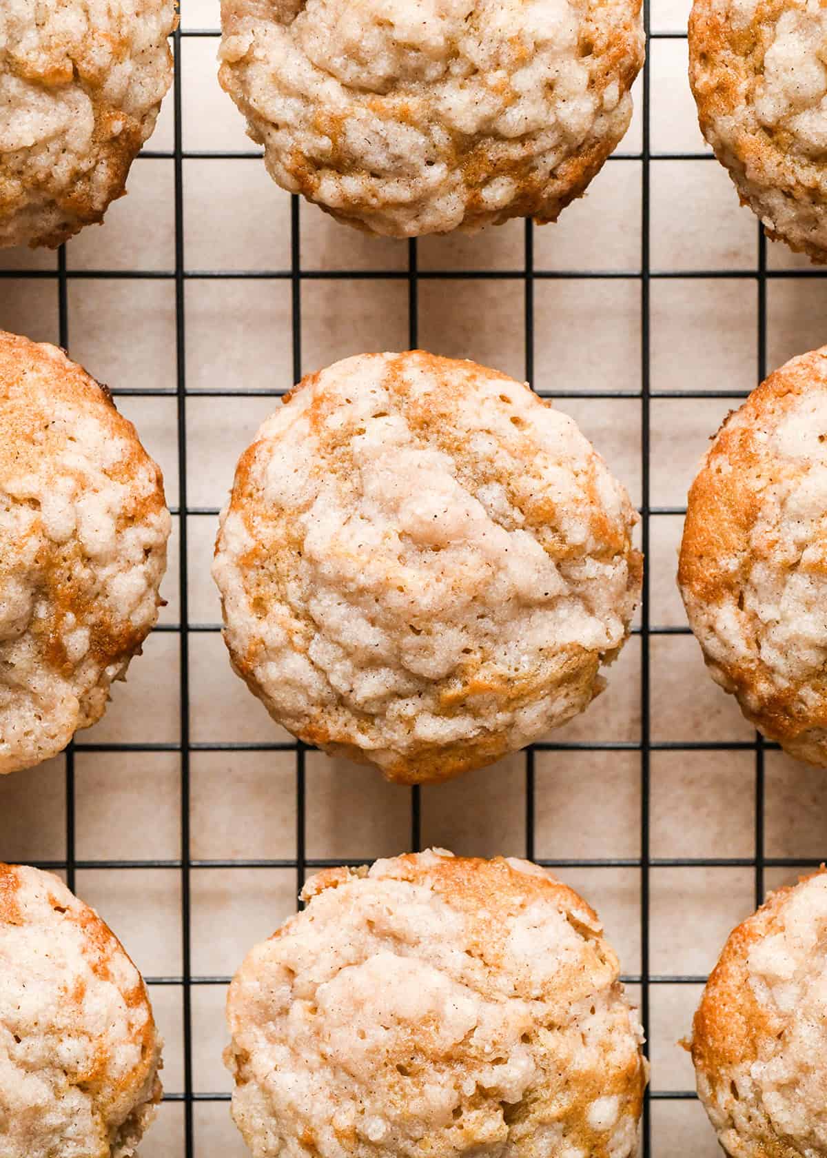 9 banana crumb muffins with crumb topping on a wire cooling rack