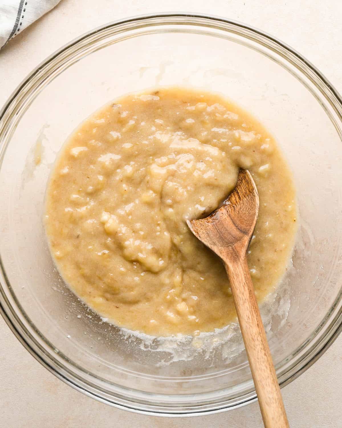 making banana crumb muffins - melted butter and banana in a bowl after mixing