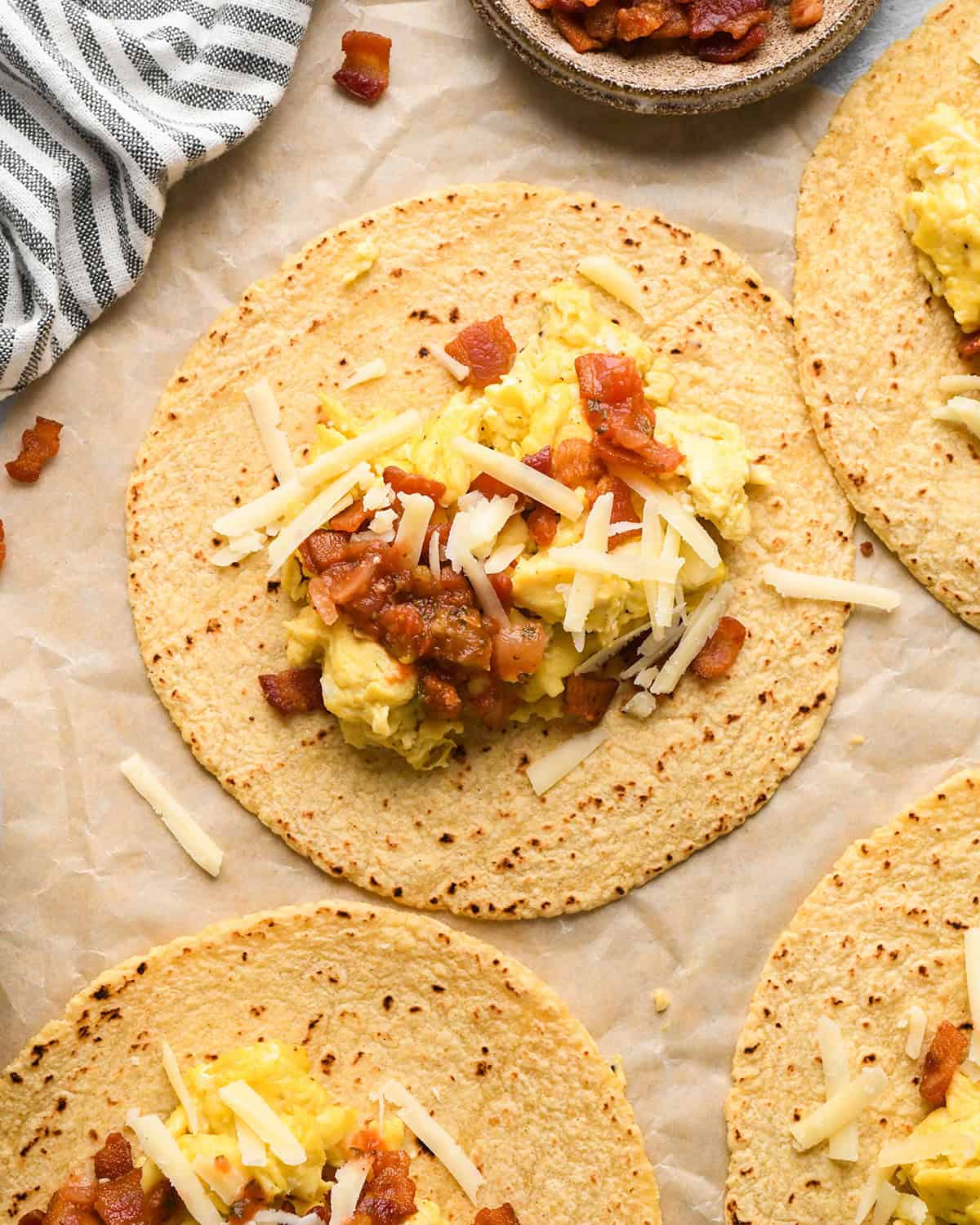 assembling breakfast tacos - adding cheese