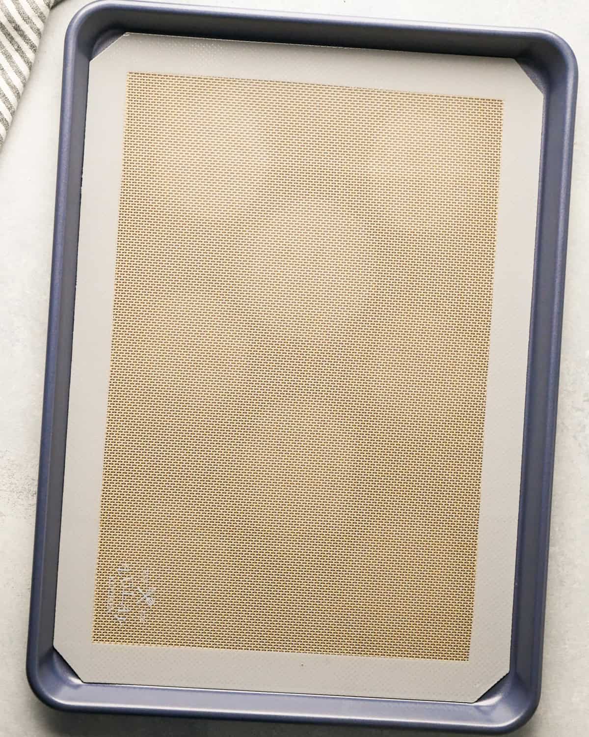 a baking sheet lined with a silicone baking mat