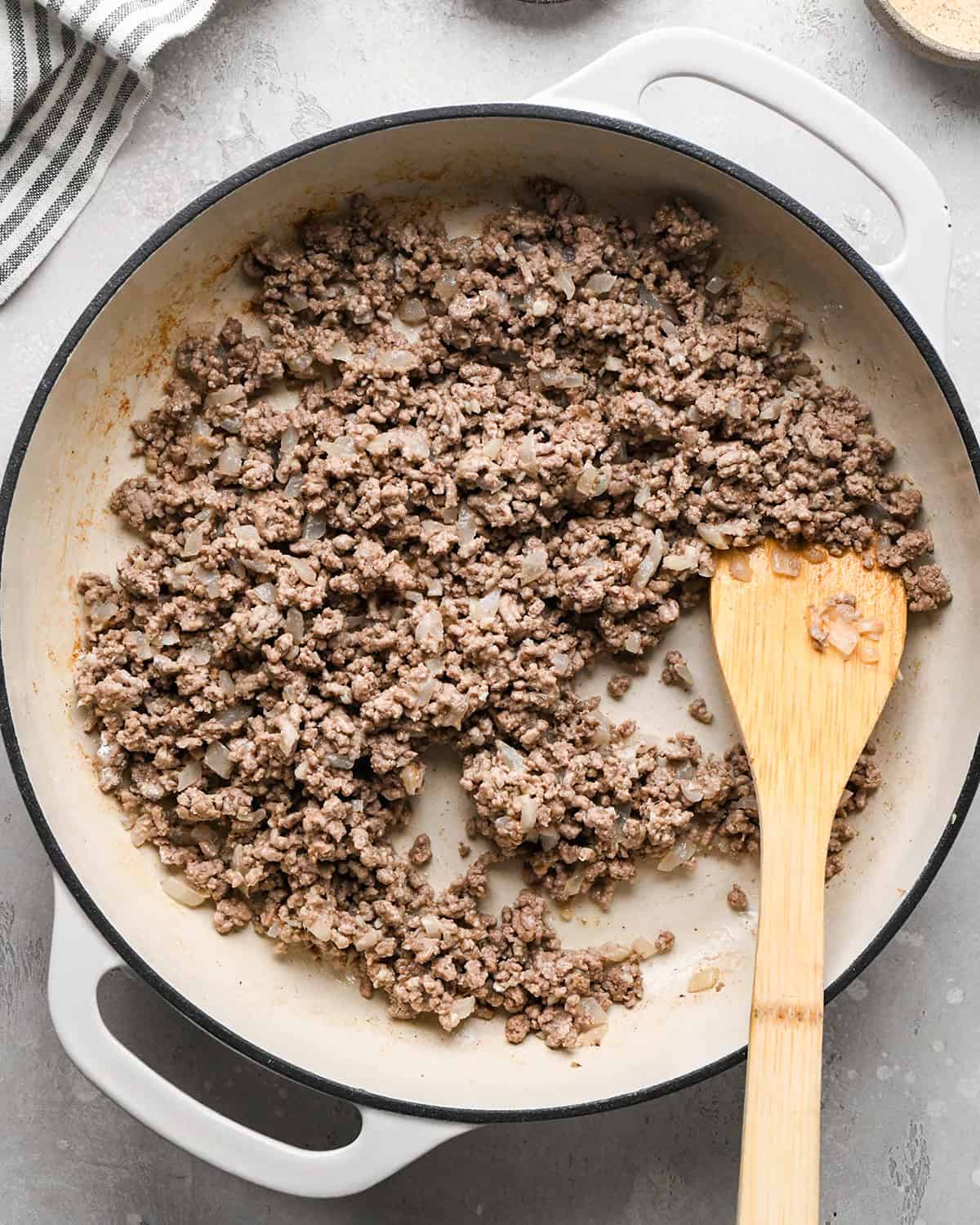 making Ground Beef Tortellini - ground beef & butter in a pan mixed with a spatula 