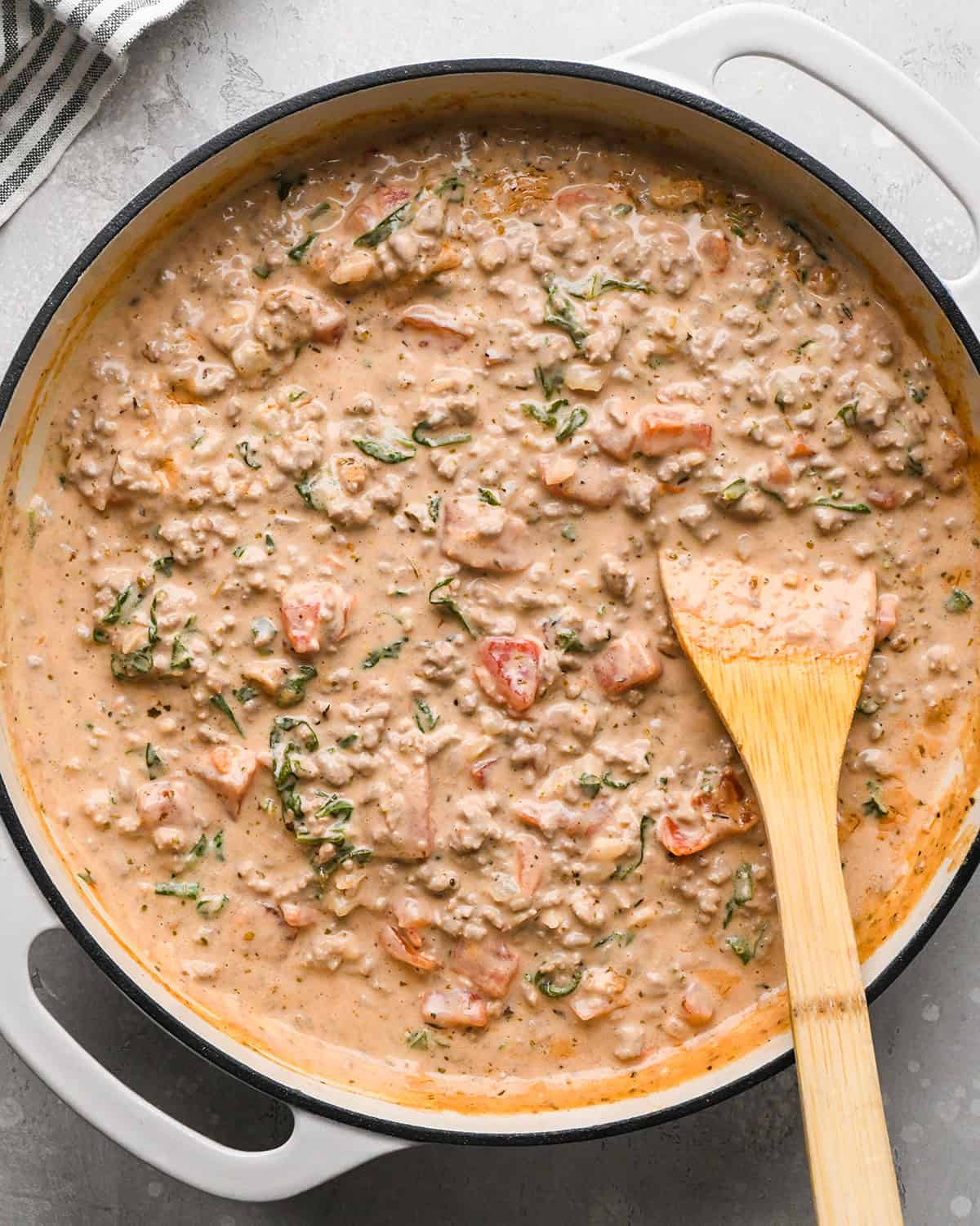 making Ground Beef Tortellini - sauce mixed with the ground beef mixture in a pan