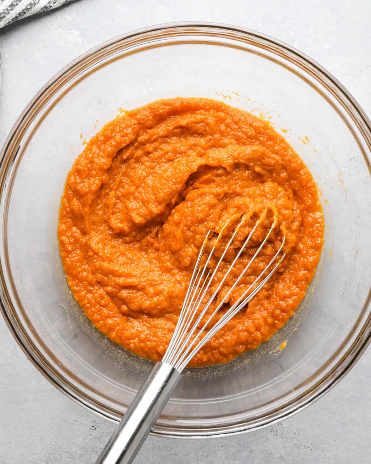 making Pumpkin Chocolate Chip Bread - whisked wet ingredients in a glass bowl with a whisk