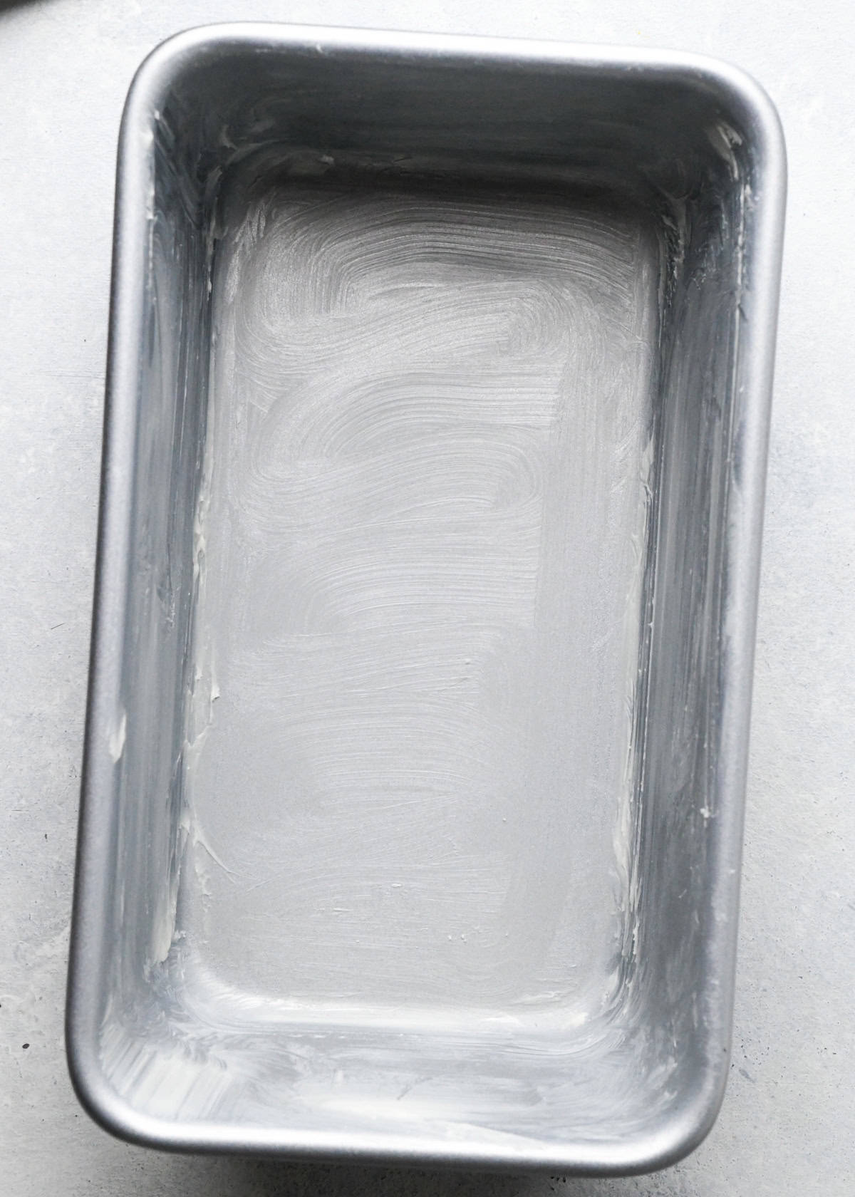 a metal loaf pan greased with butter