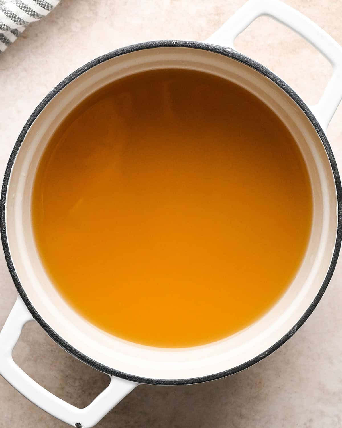 Making butternut squash risotto - 3 cups chicken broth in a white 3-quart saucepan