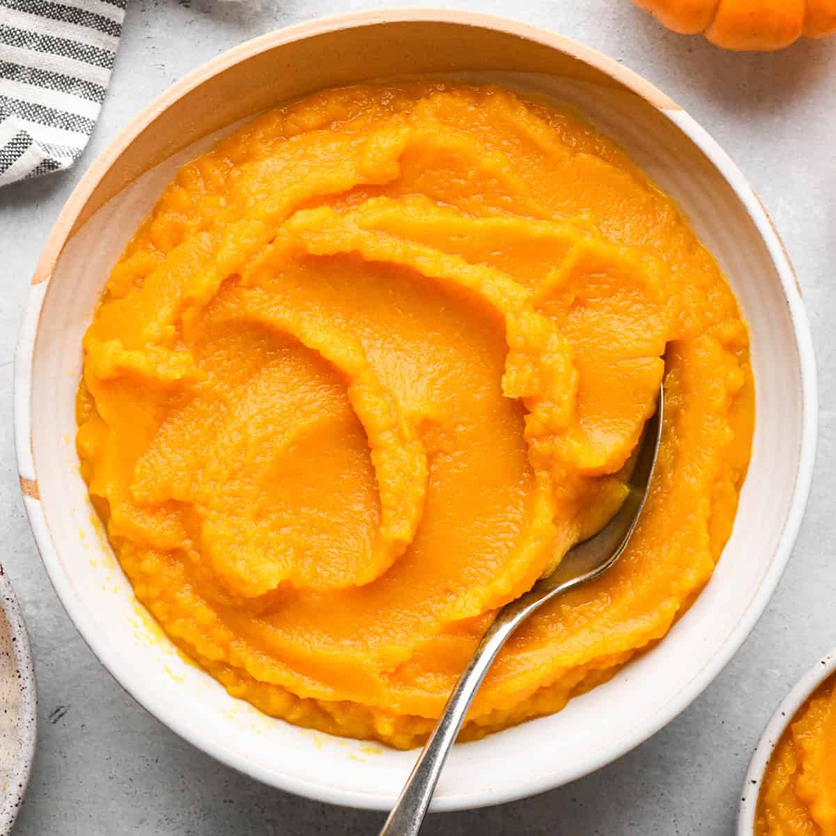homemade pumpkin puree in a bowl with a spoon