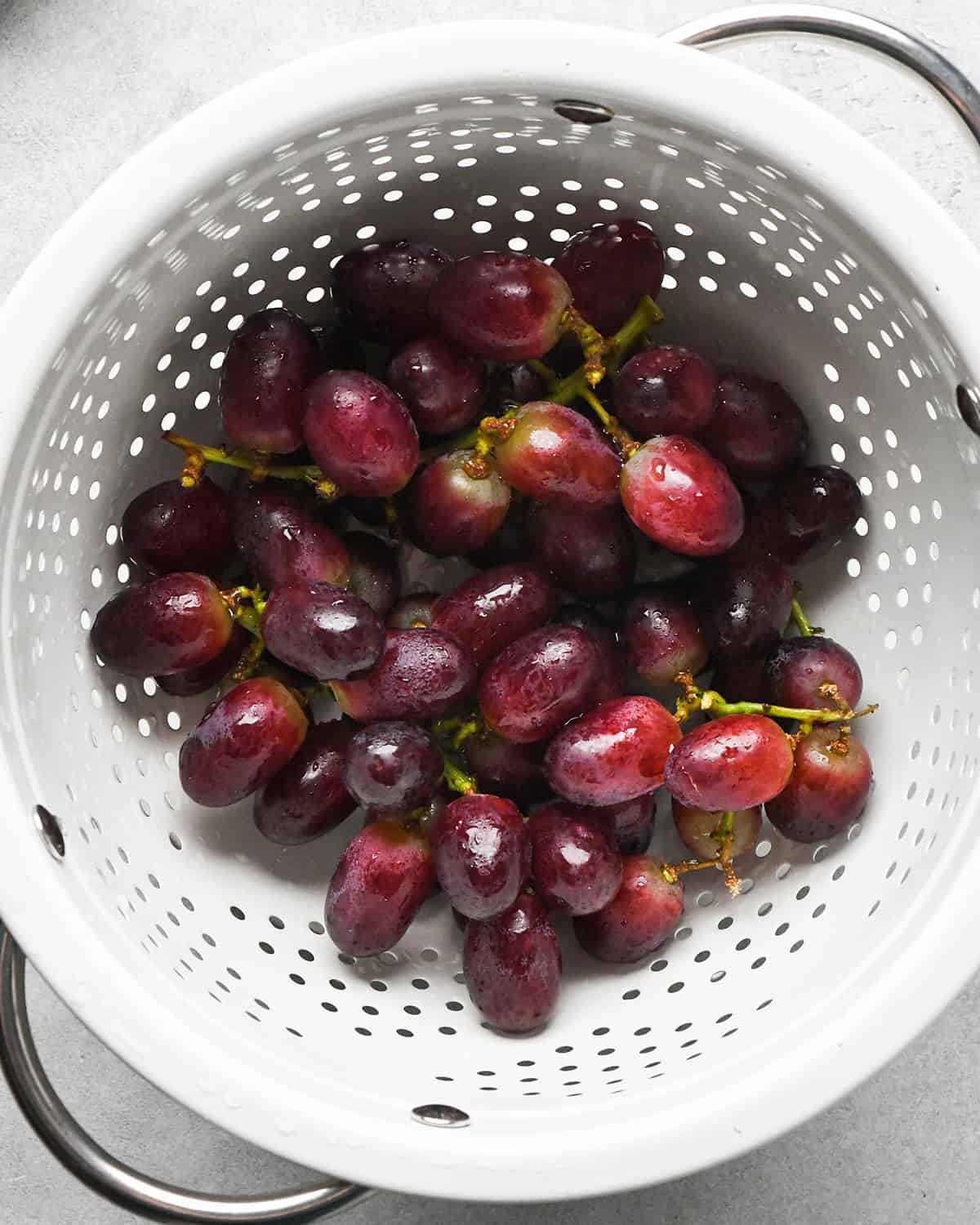 How to Make a Charcuterie Board - red grapes in a colander