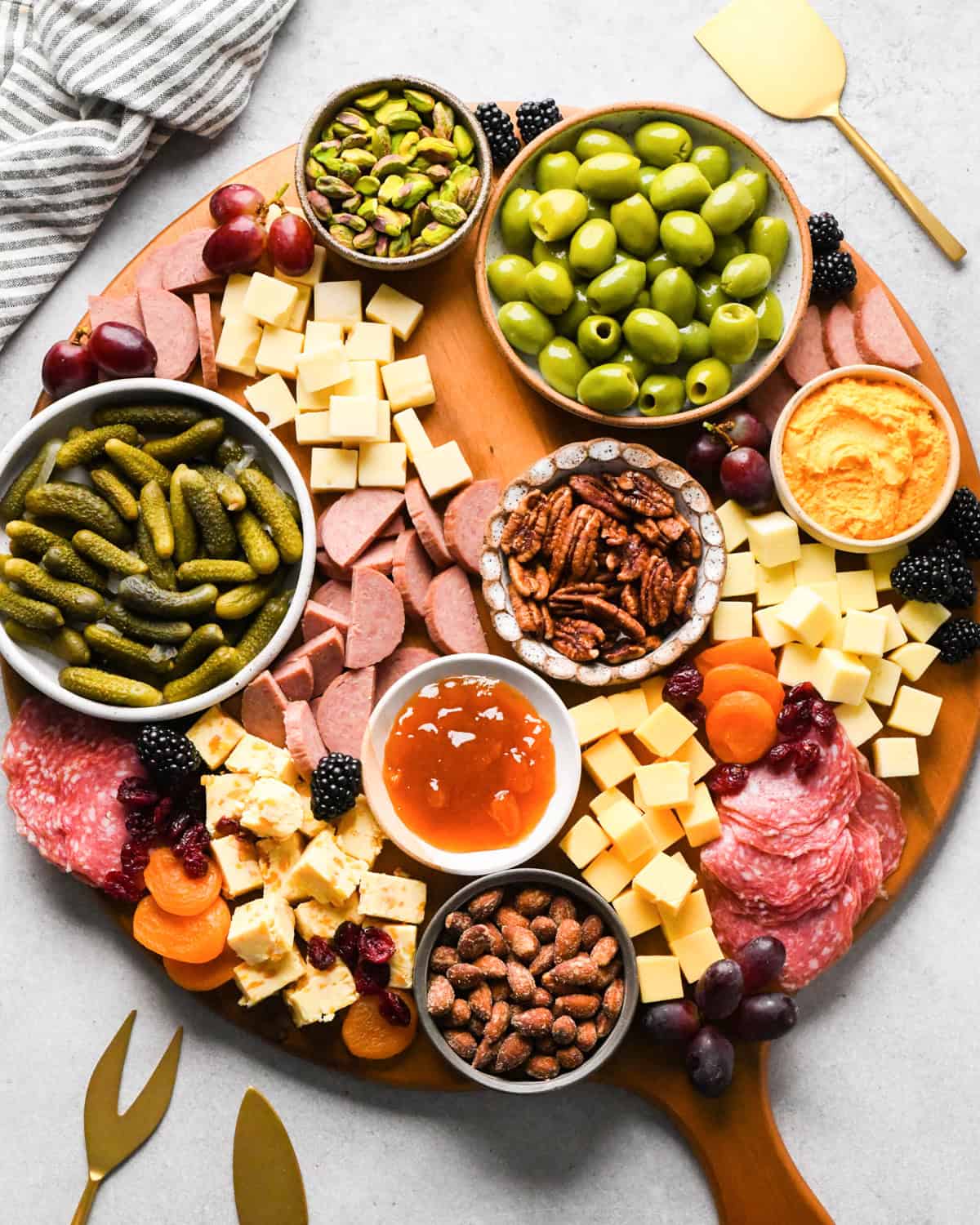 assembling a charcuterie board - fresh and dried fruit added 