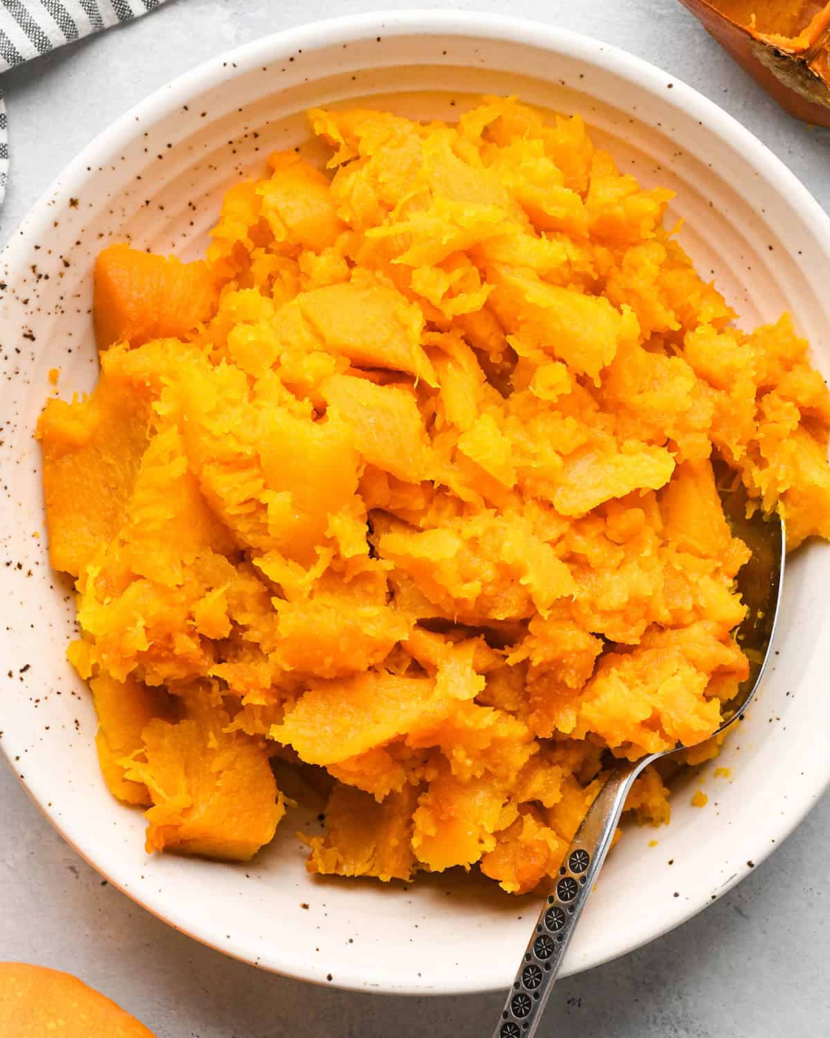 pumpkin pulp (flesh) in a bowl with a spoon