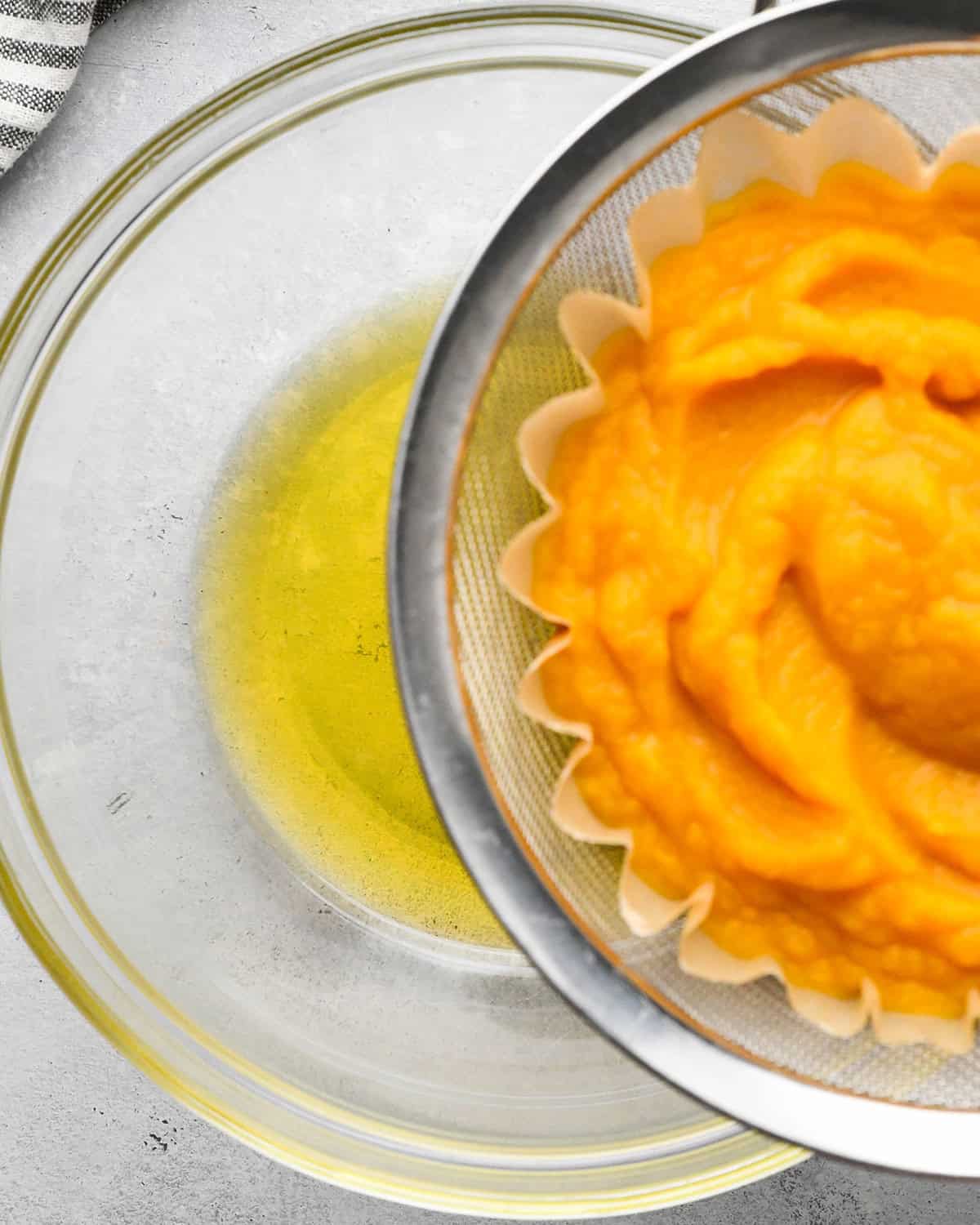 How to Make Pumpkin Puree - photo showing the water in a bowl that drained out of pumpkin puree on top of it