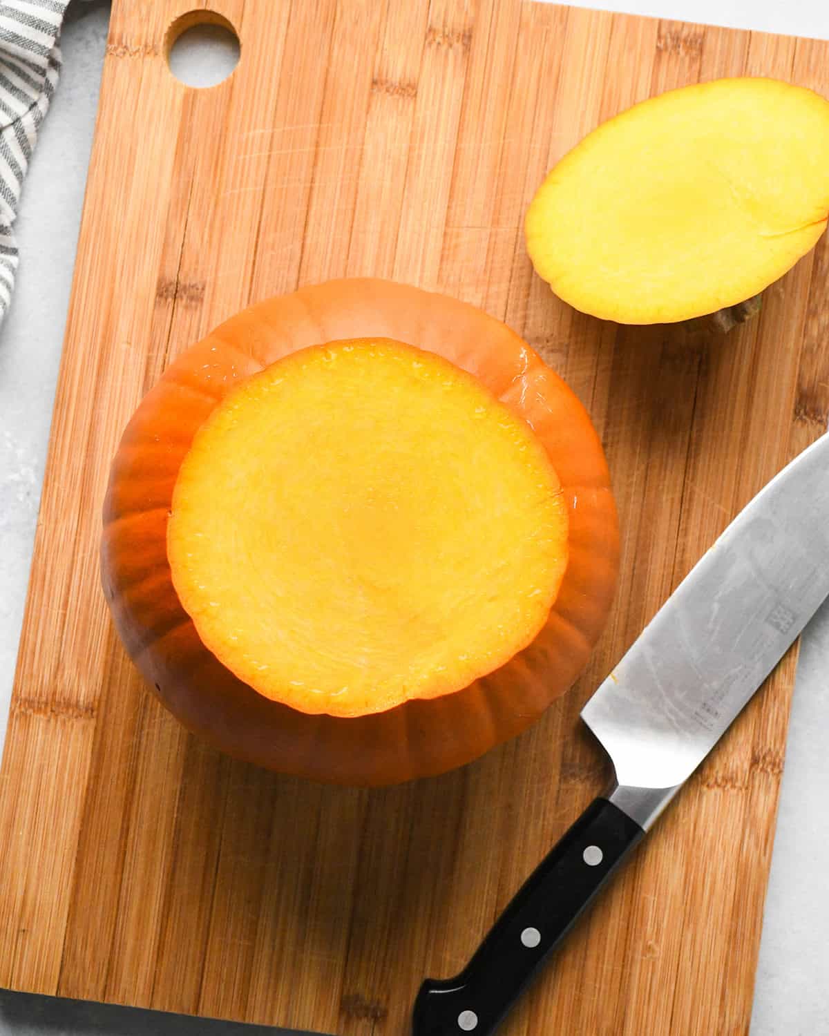 How to Make Pumpkin Puree - a pie pumpkin with the top  and stem cut off