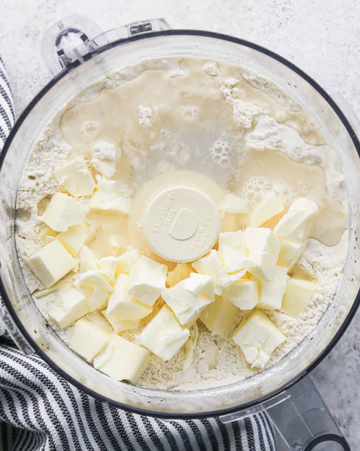 butter and water added to the flour in a food processor before mixing making pie crust cookies