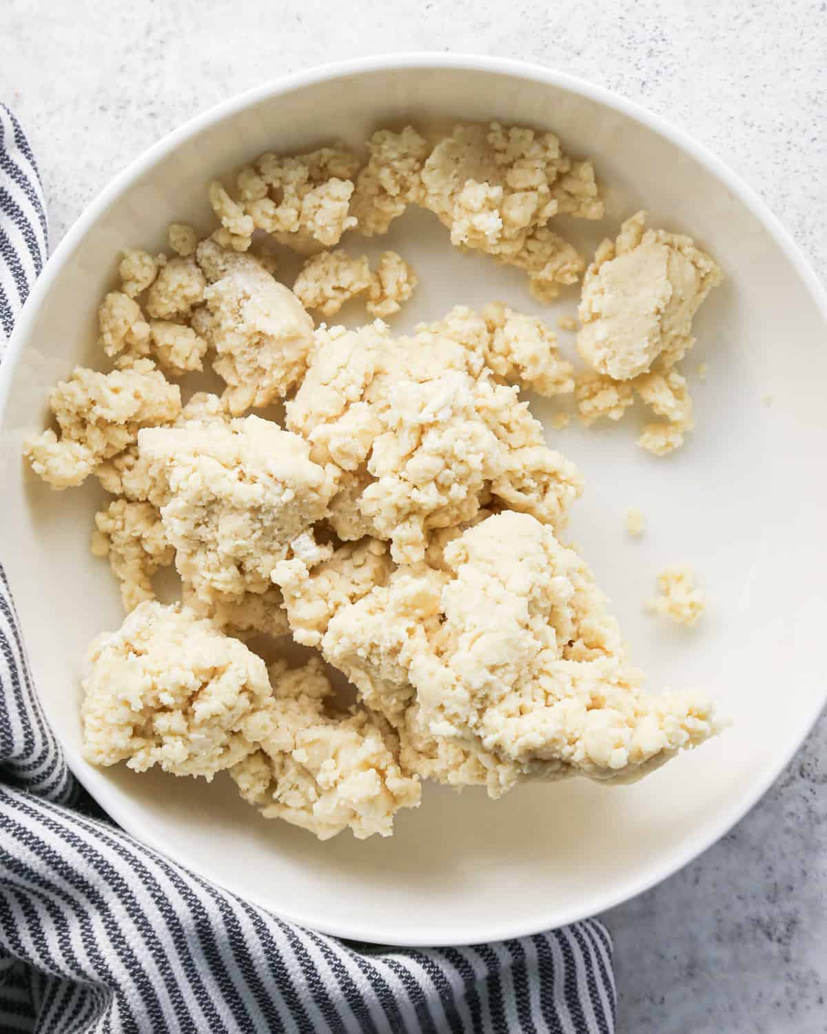 pie crust dough in a white bowl to be used to make pie crust cookies